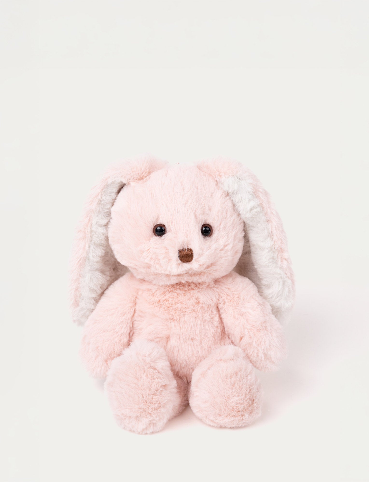  Image of Soft pink plush bunny with long floppy ears, brown eyes, and a stitched brown nose.