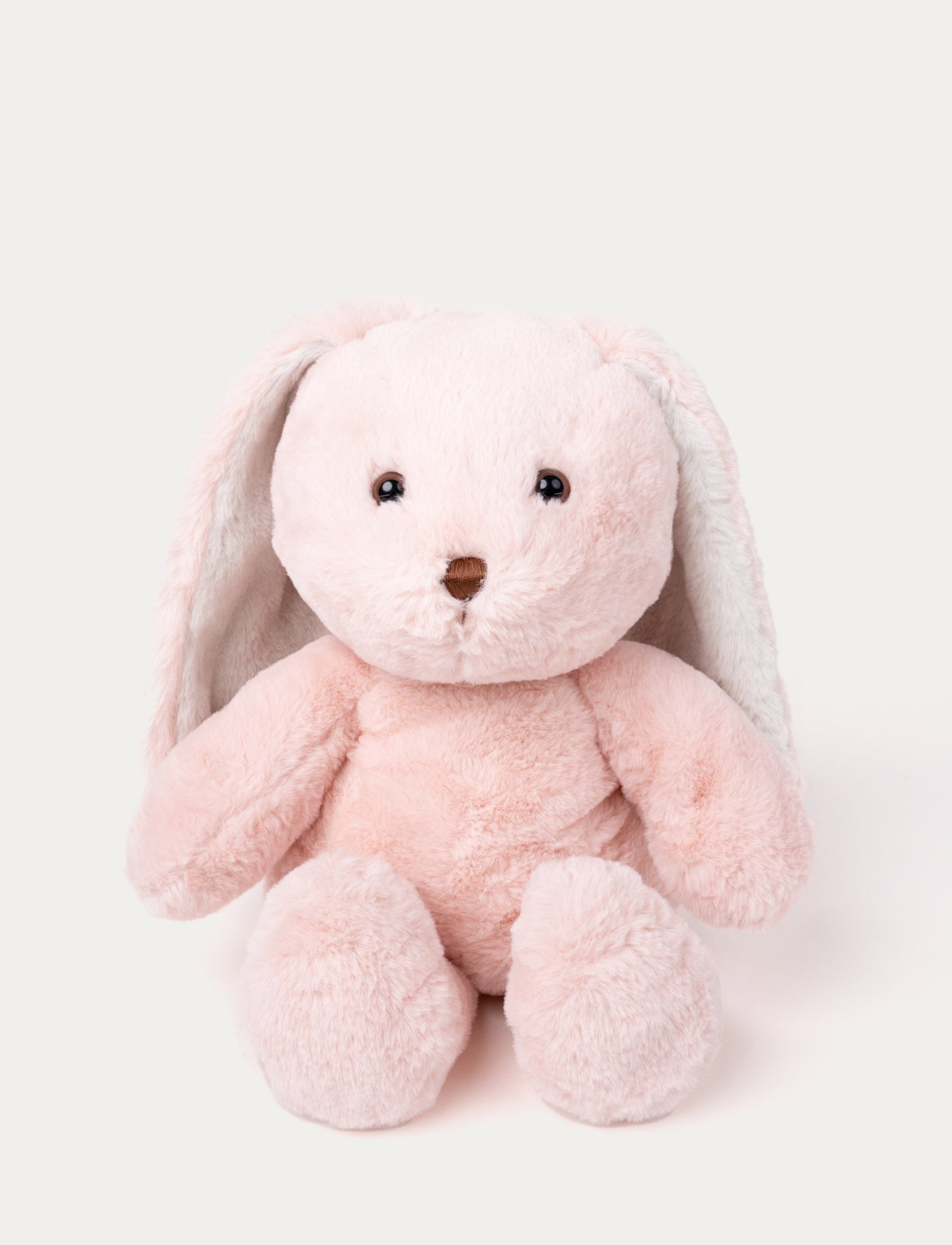 Image of Soft pink plush bunny with long floppy ears, brown eyes, and a stitched brown nose.