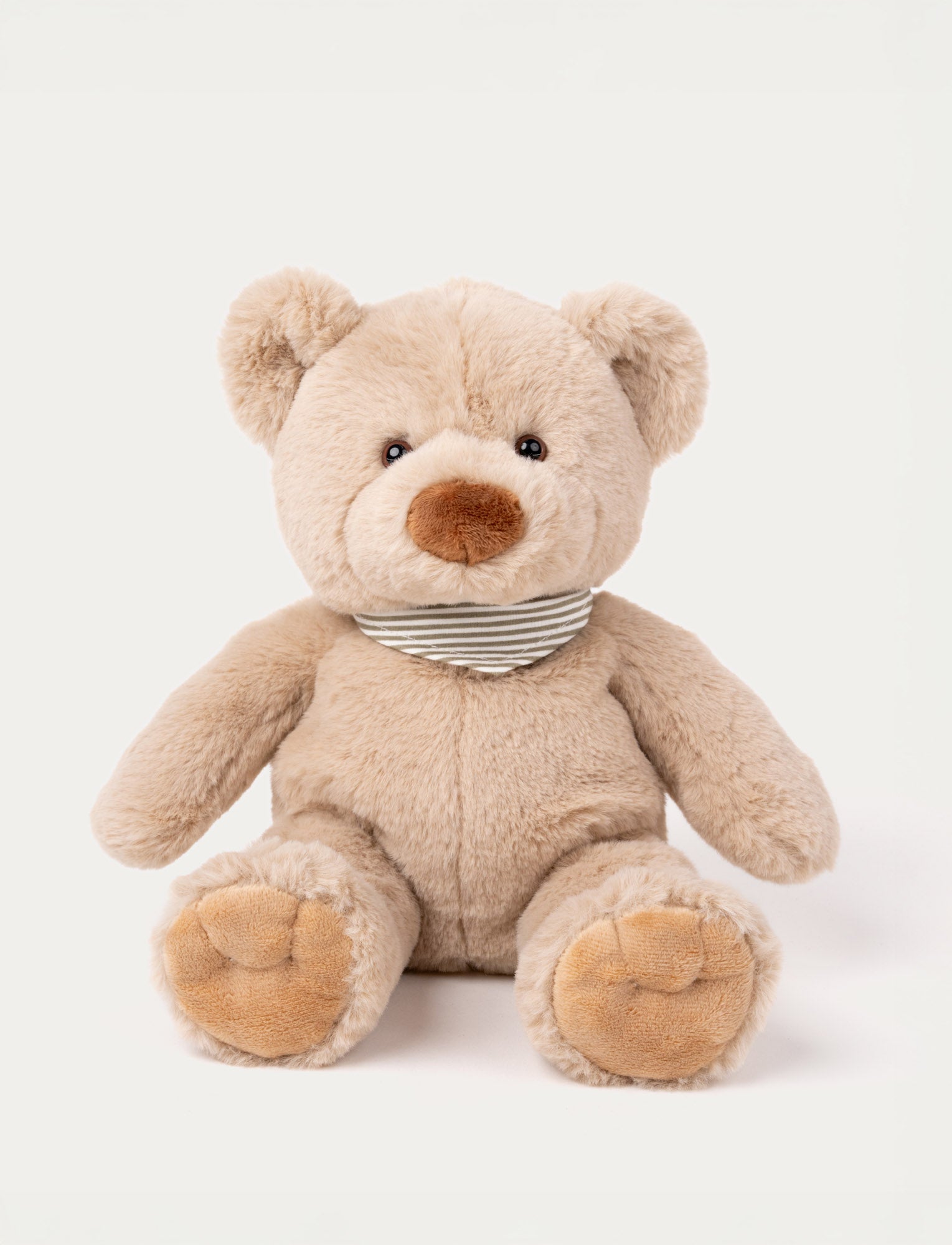  Image of Soft beige teddy bear with a brown nose, black eyes, and a striped gray and white scarf around its neck.