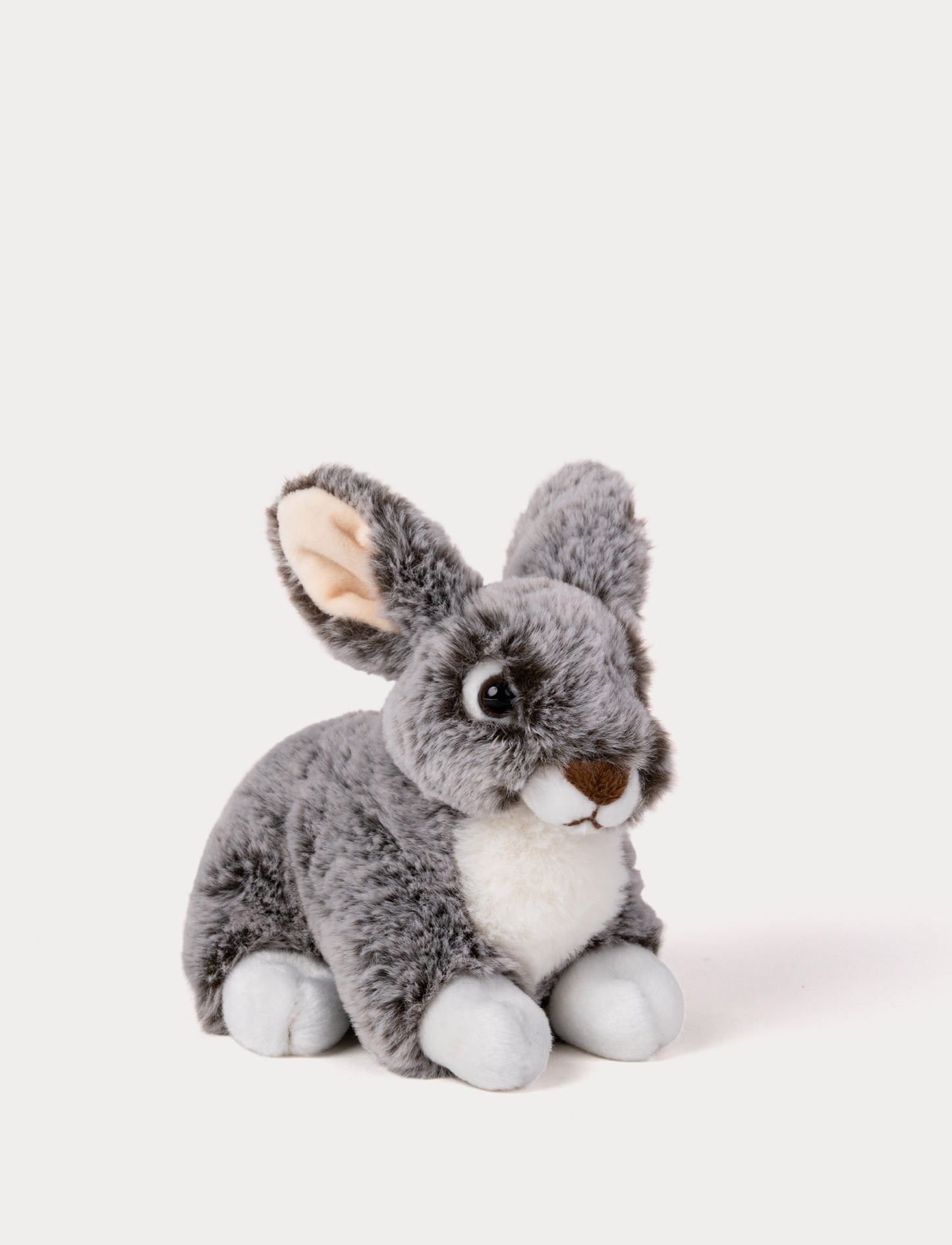 Grey Plush toy rabbit on a white background
