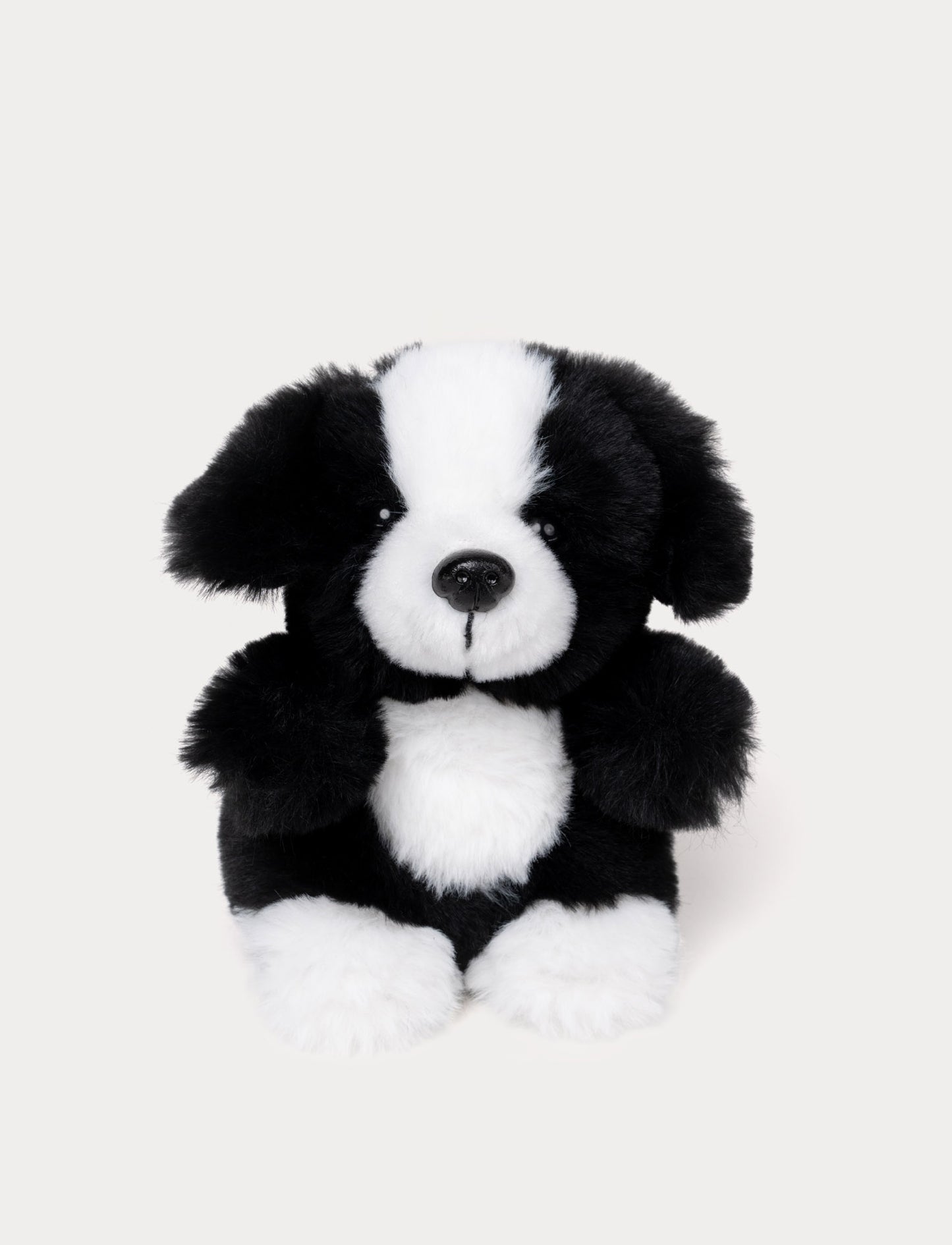 Black and white small plush dog