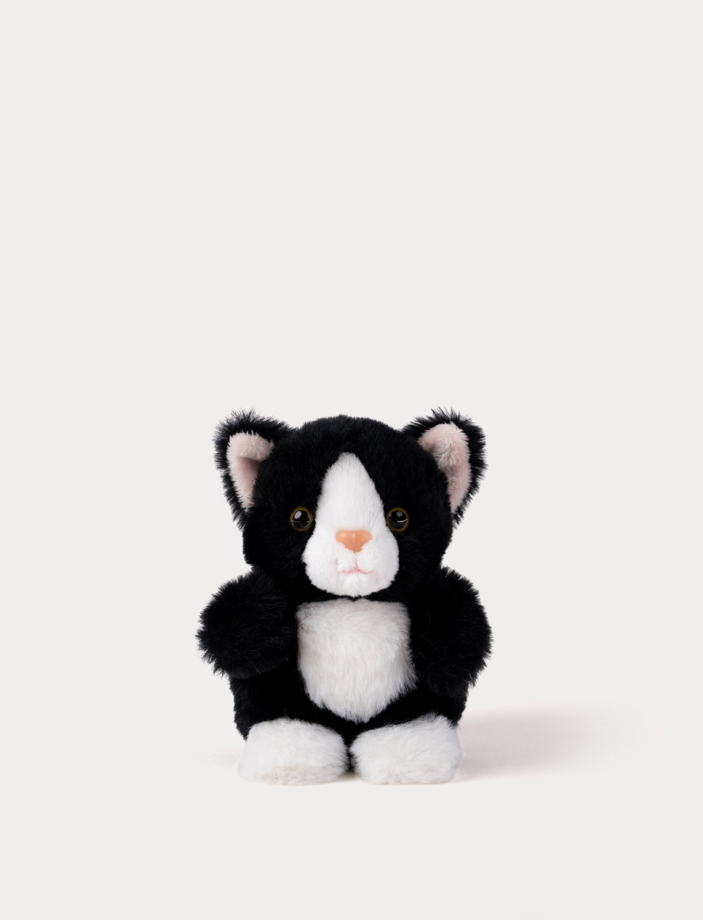 Black and white plush cat toy on a white background