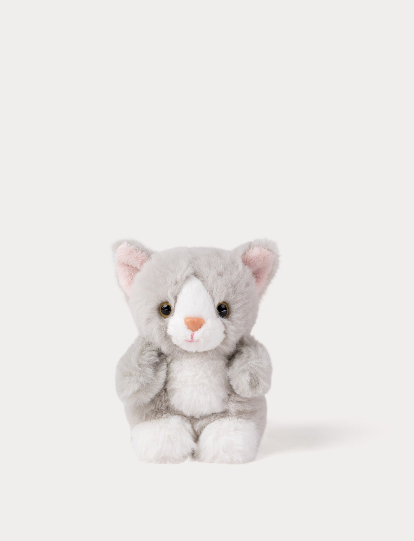 Small grey plush toy cat on a white background