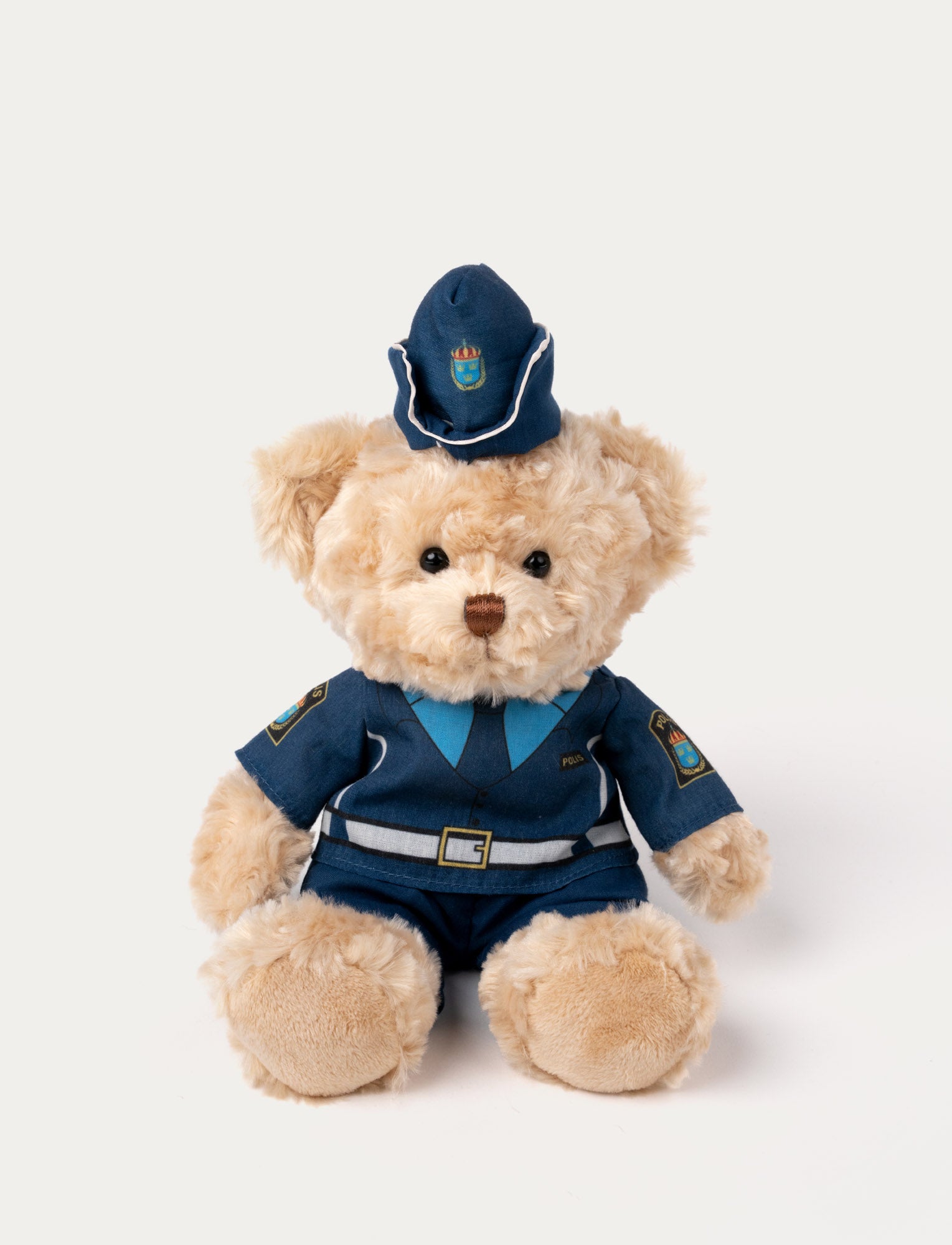  Image of Plush teddy bear with light beige fur, dressed in a Swedish police uniform with a matching hat and emblem details.