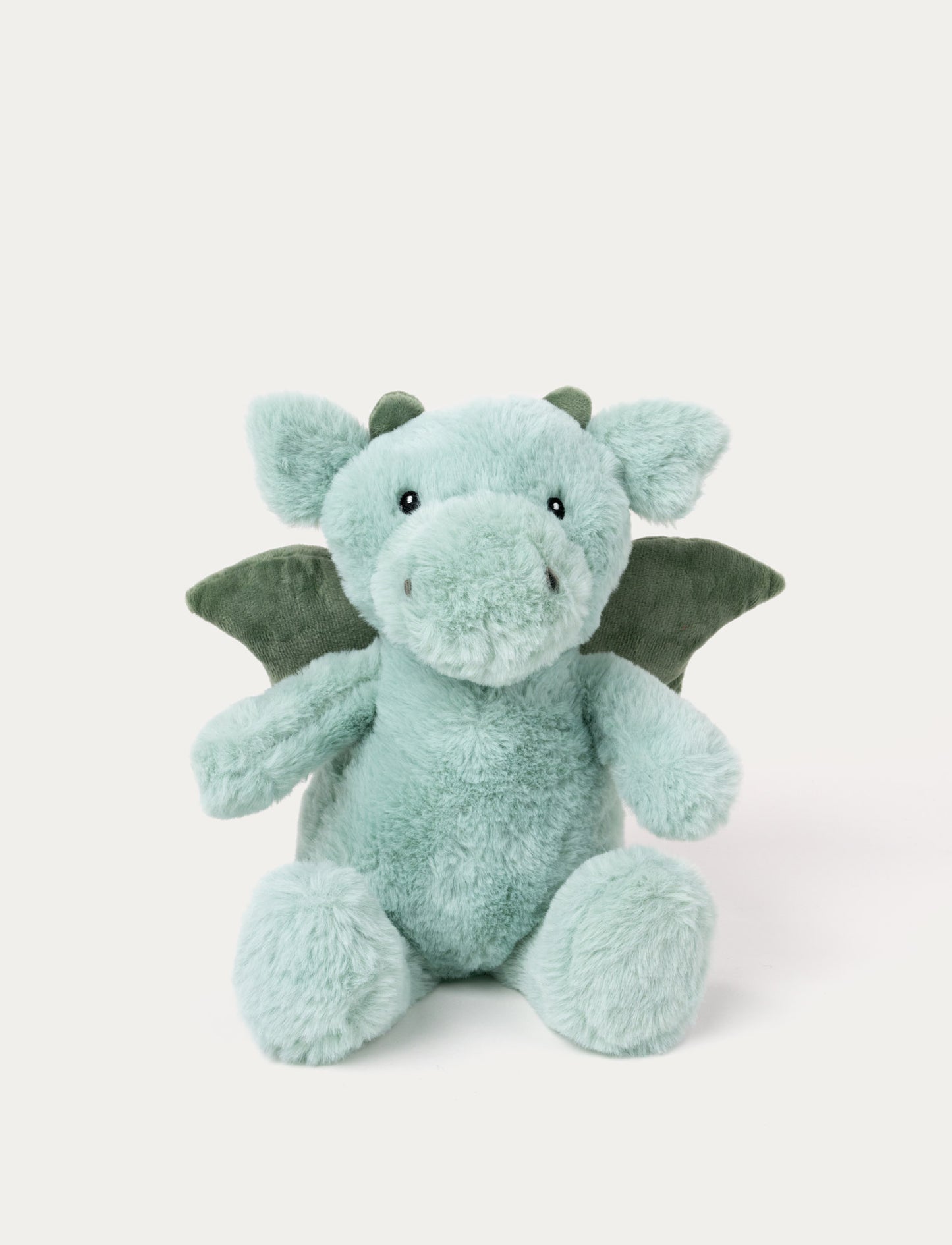 Soft, plush dino in light green with darker green wings and horns, black button eyes, and a friendly expression.