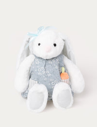 Soft, white plush bunny with long floppy ears, wearing a blue floral dress with a pocket holding a small plush carrot.