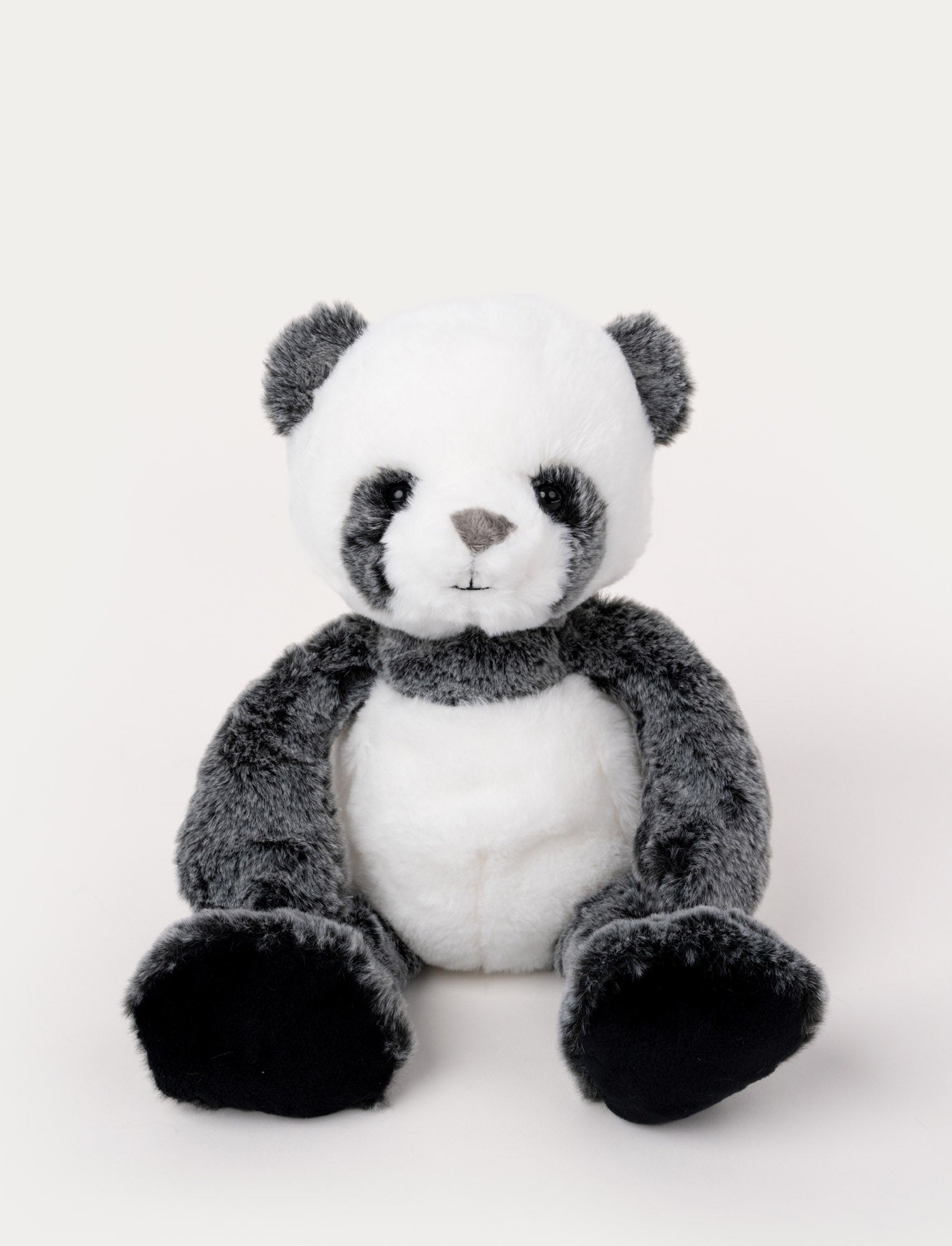  Image of Soft, plush panda with black and white fur, black button eyes, and large black paws, sitting upright.