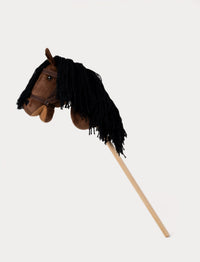 Brown hobby horse with a soft mane, stylish bridle, and a sturdy wooden stick.