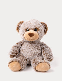 A teddy bear with mottled brown fur, velvety paws, bright eyes, and a cheerful expression.