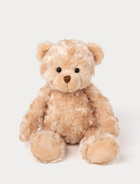 Soft, plush teddy bear with curly light brown fur, black button eyes, a stitched brown nose, and beige paw pads.