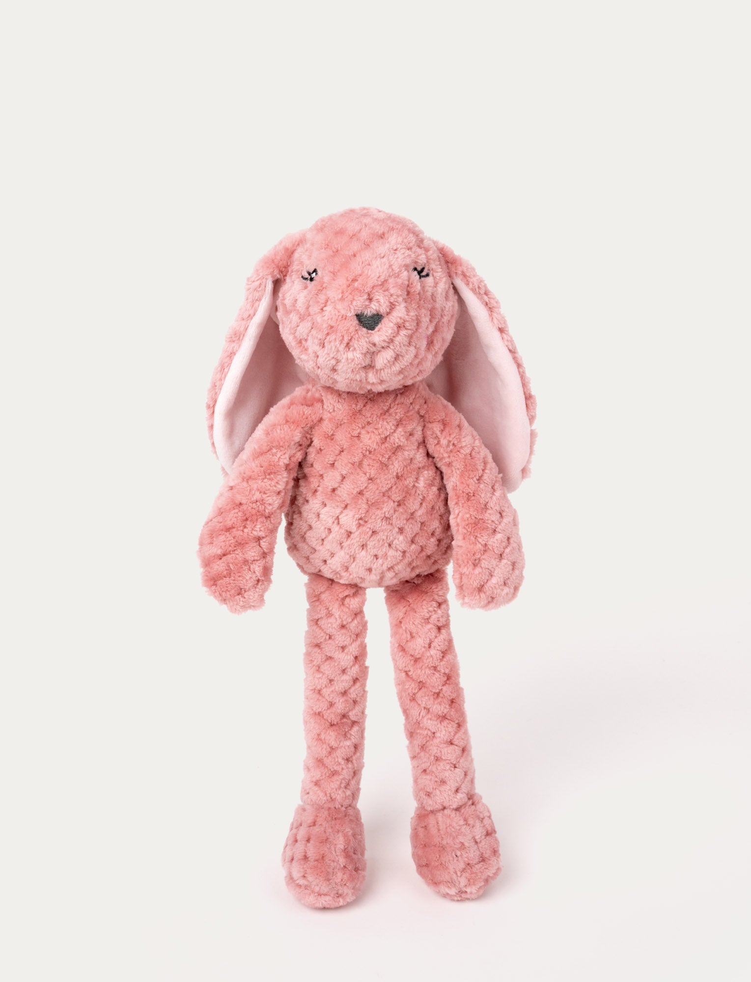  Image of Soft plush bunny with textured pink fur, long floppy ears, embroidered eyes, and a stitched nose.