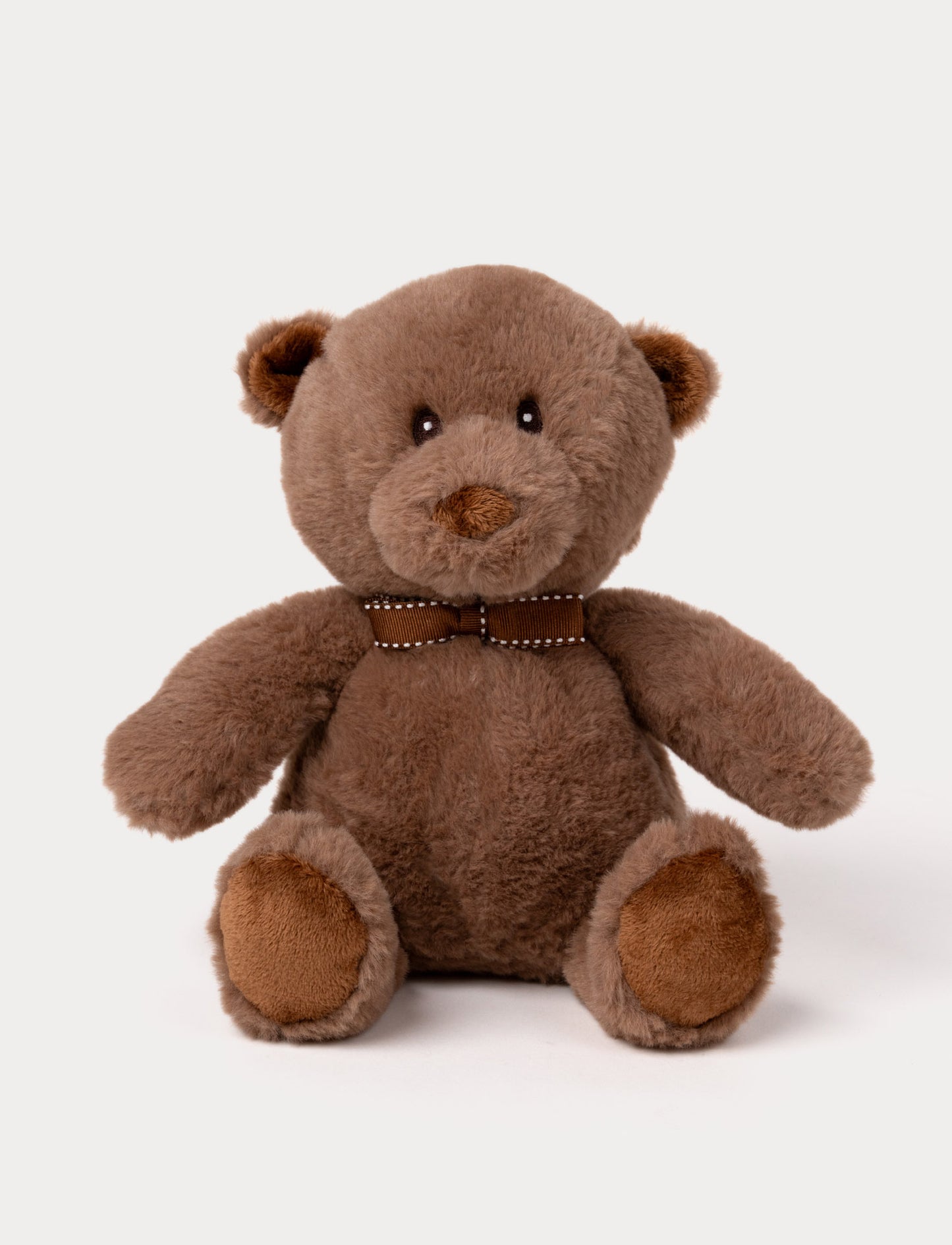 Soft plush teddy bear with warm brown fur, embroidered eyes, a brown bowtie, and matching paw pads.