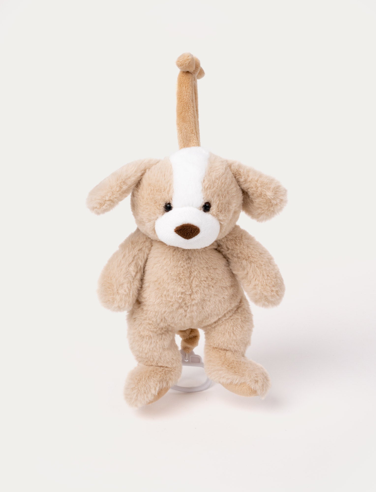  Image of Soft plush puppy music toy with beige and white fur, floppy ears, and a pull string for playing a lullaby.
