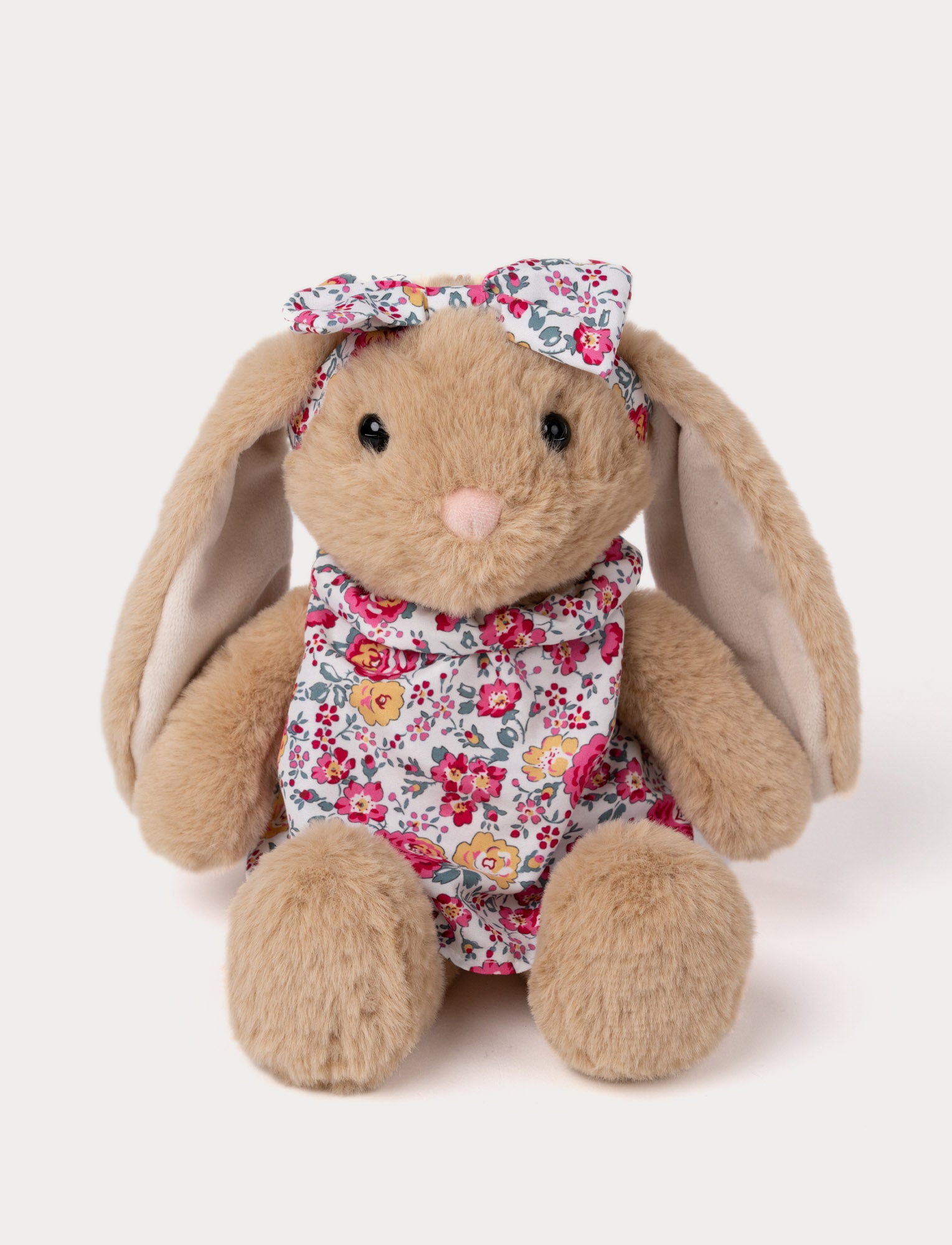  Image of Soft plush bunny with long floppy ears, wearing a floral dress and matching bow.
