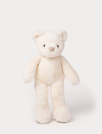 White plush teddy bear with long legs, round ears, and a soft beige nose.