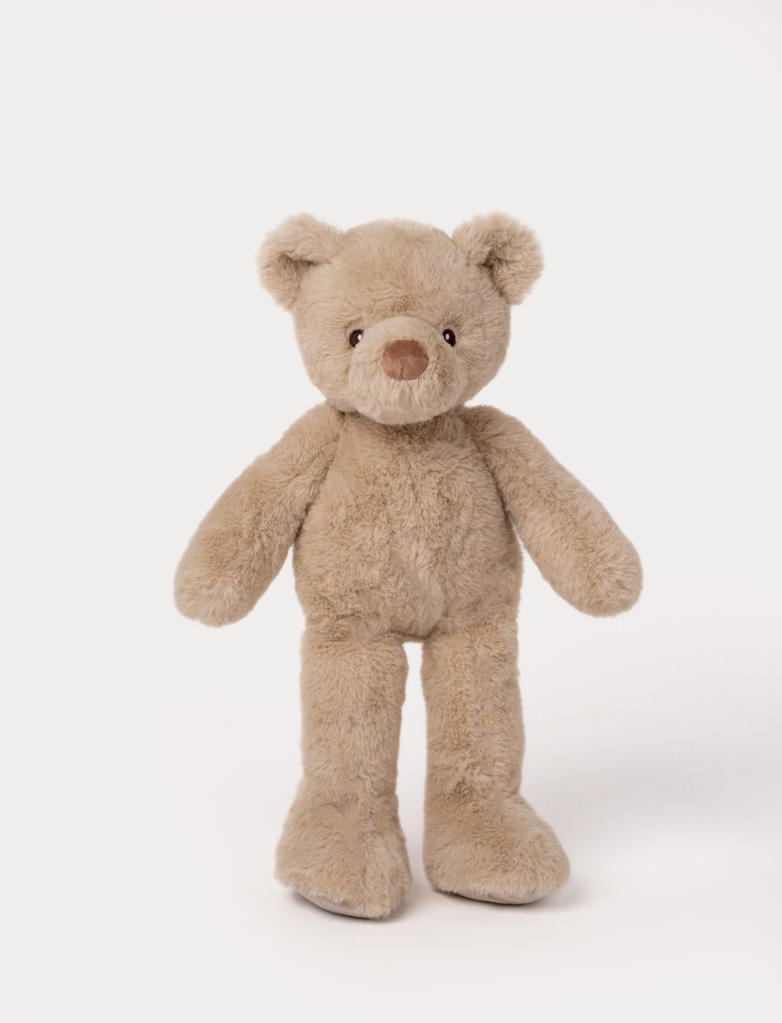  Image of Beige plush teddy bear with long legs, round ears, and a soft brown nose.