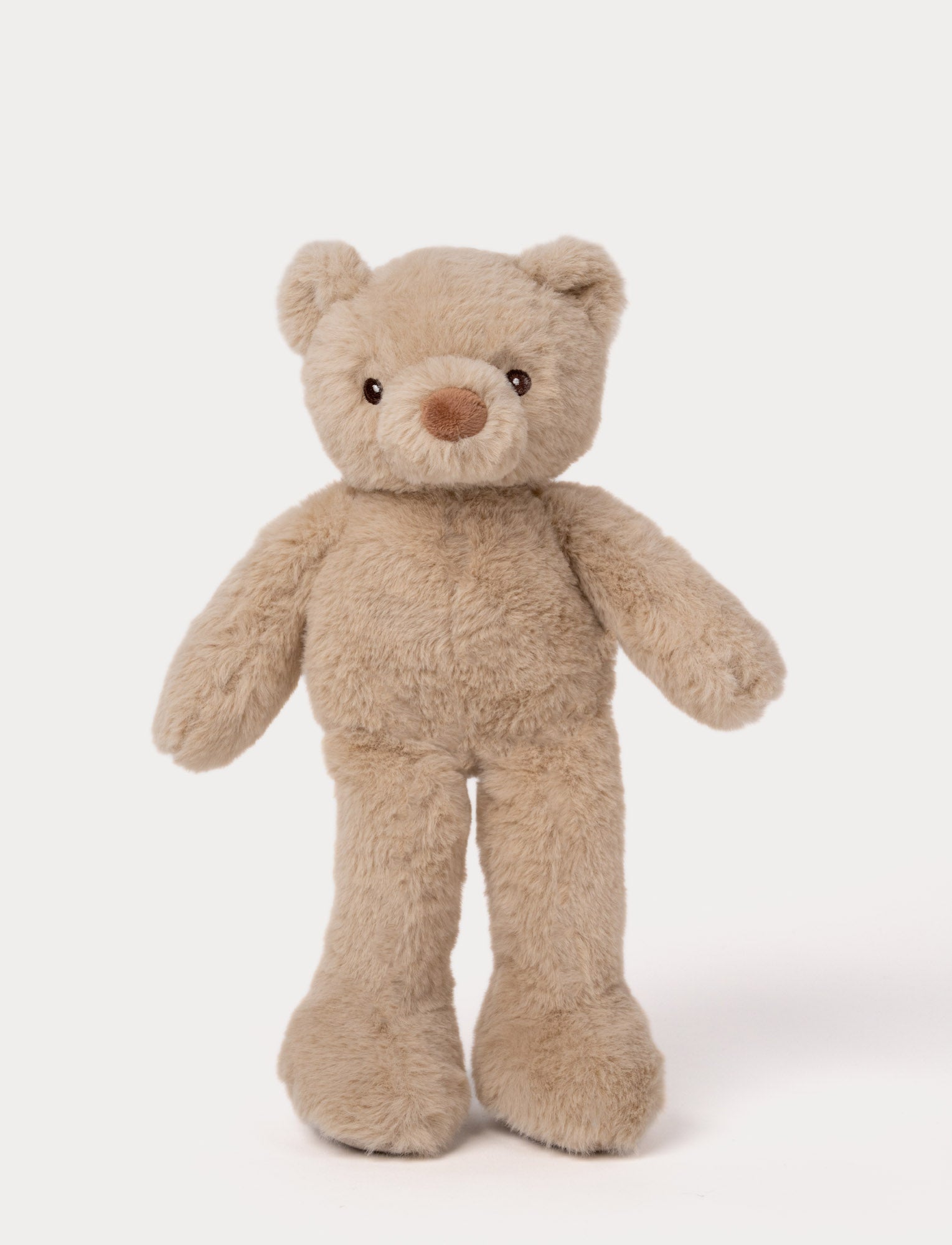  Image of Beige plush teddy bear with long legs, round ears, and a soft brown nose.