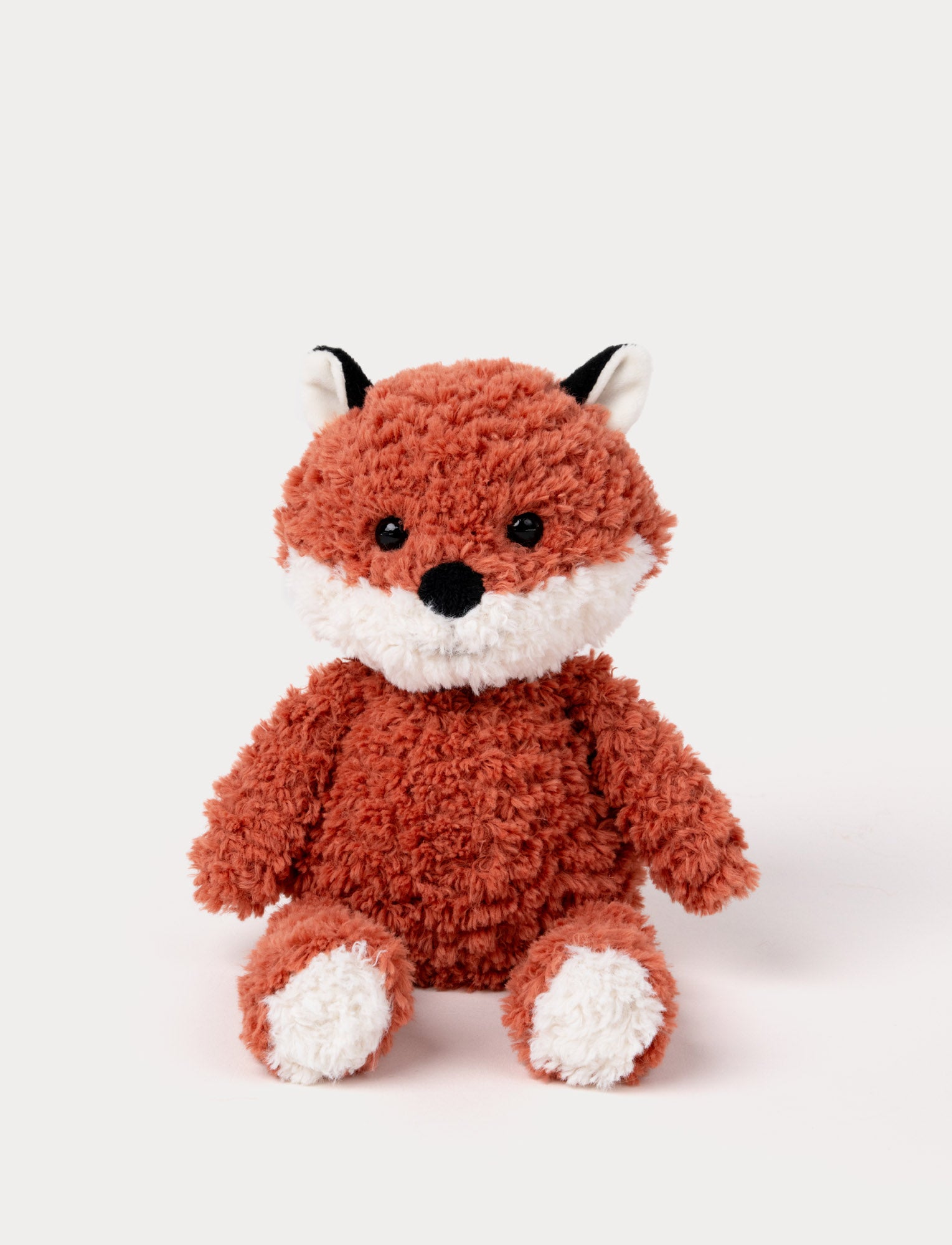  Image of Soft plush fox with a curly-textured red coat, white accents on the face, paws, and ears