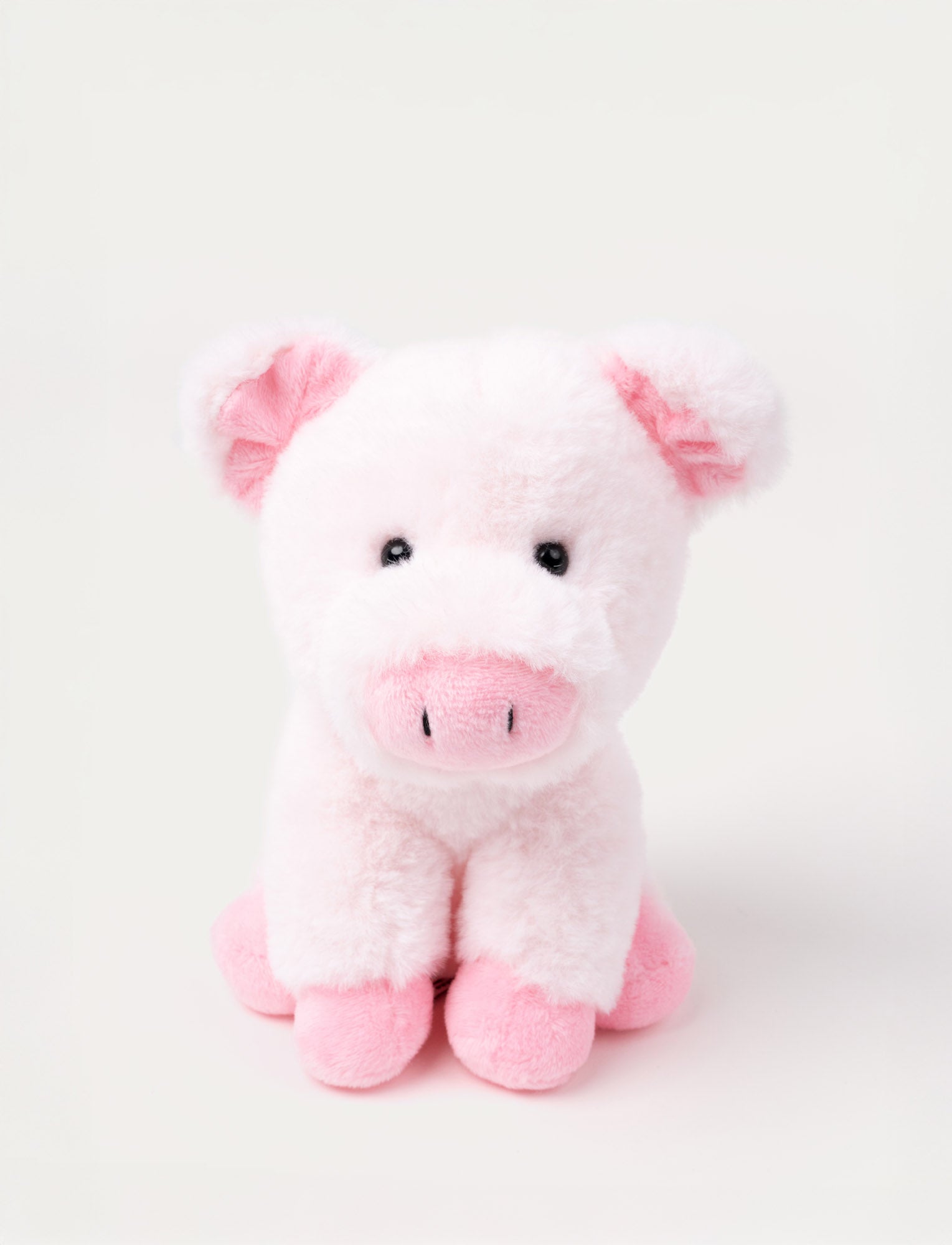  Image of A small pig with light pink soft fur and a gentle expression, sitting in a cozy pose.