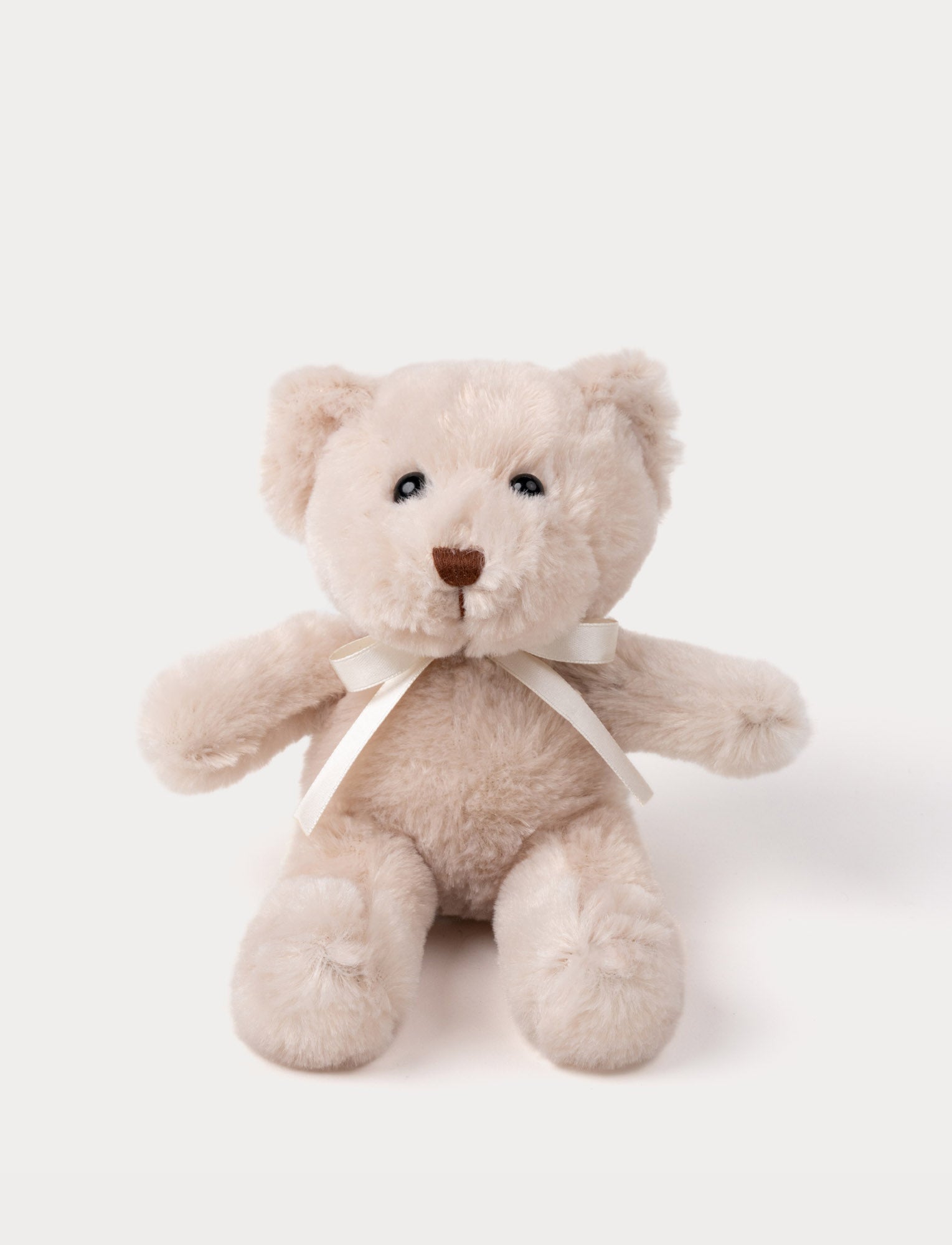  Image of A teddy bear with warm beige fur, an embroidered nose, and an adorable satin bow.