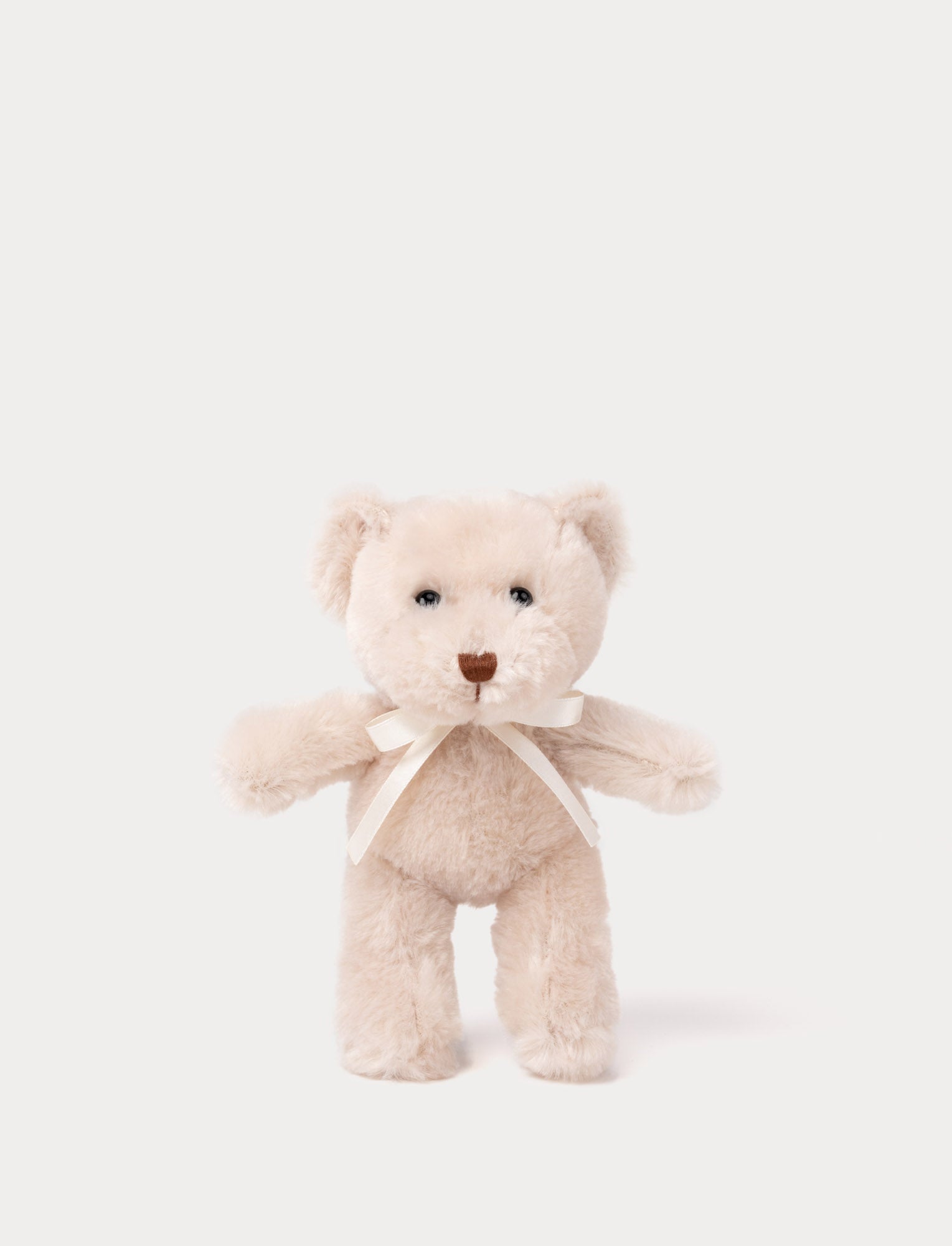  Image of A teddy bear with beige fur, an embroidered nose, and an adorable satin bow.