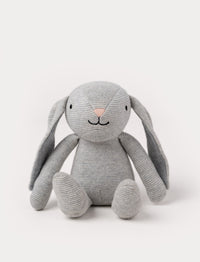 A knitted grey plush bunny with floppy ears, a stitched face, and a soft textured body.