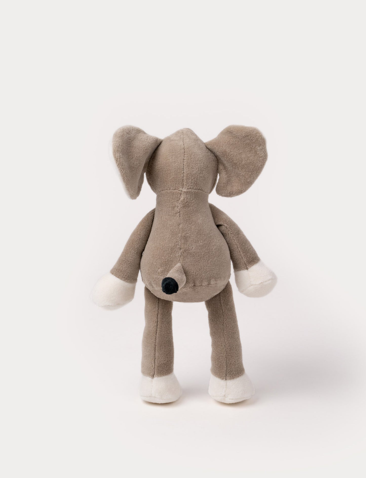 A soft plush beige bunny  with broaded eyes and nose, white, and brown details.