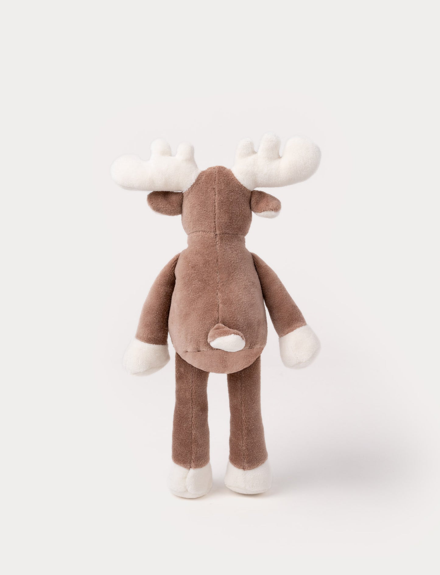A soft brown plush moose, with white antlers, a stitched face and white and brown details.