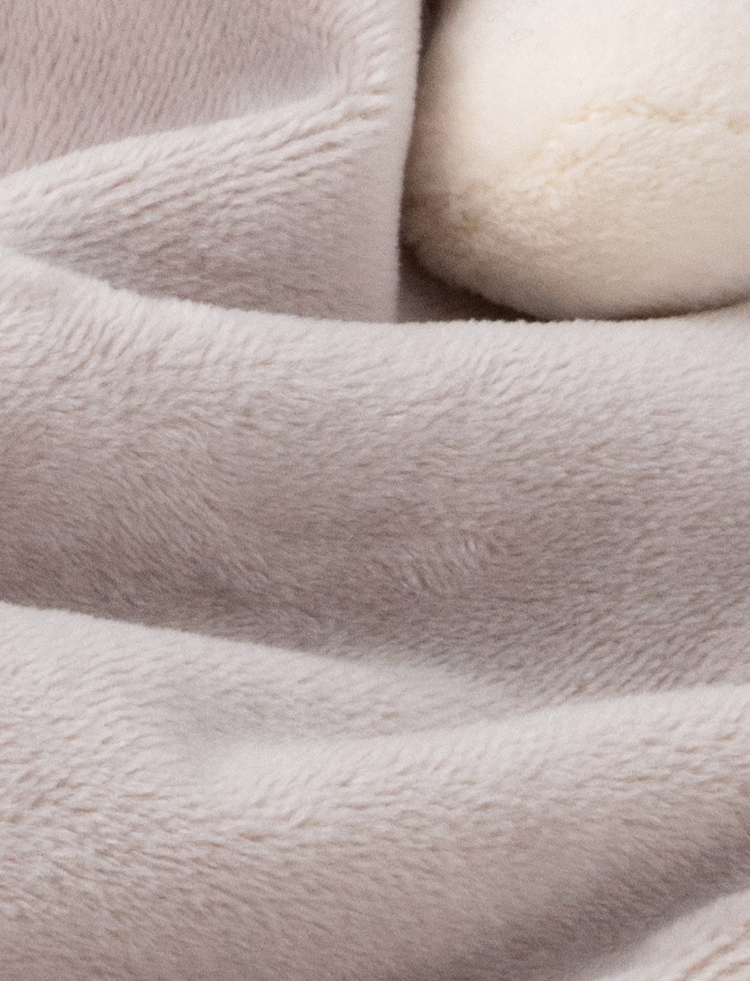  Image of Soft baby blanket with a plush gray dino head, white spikes, and cream-trimmed edges.