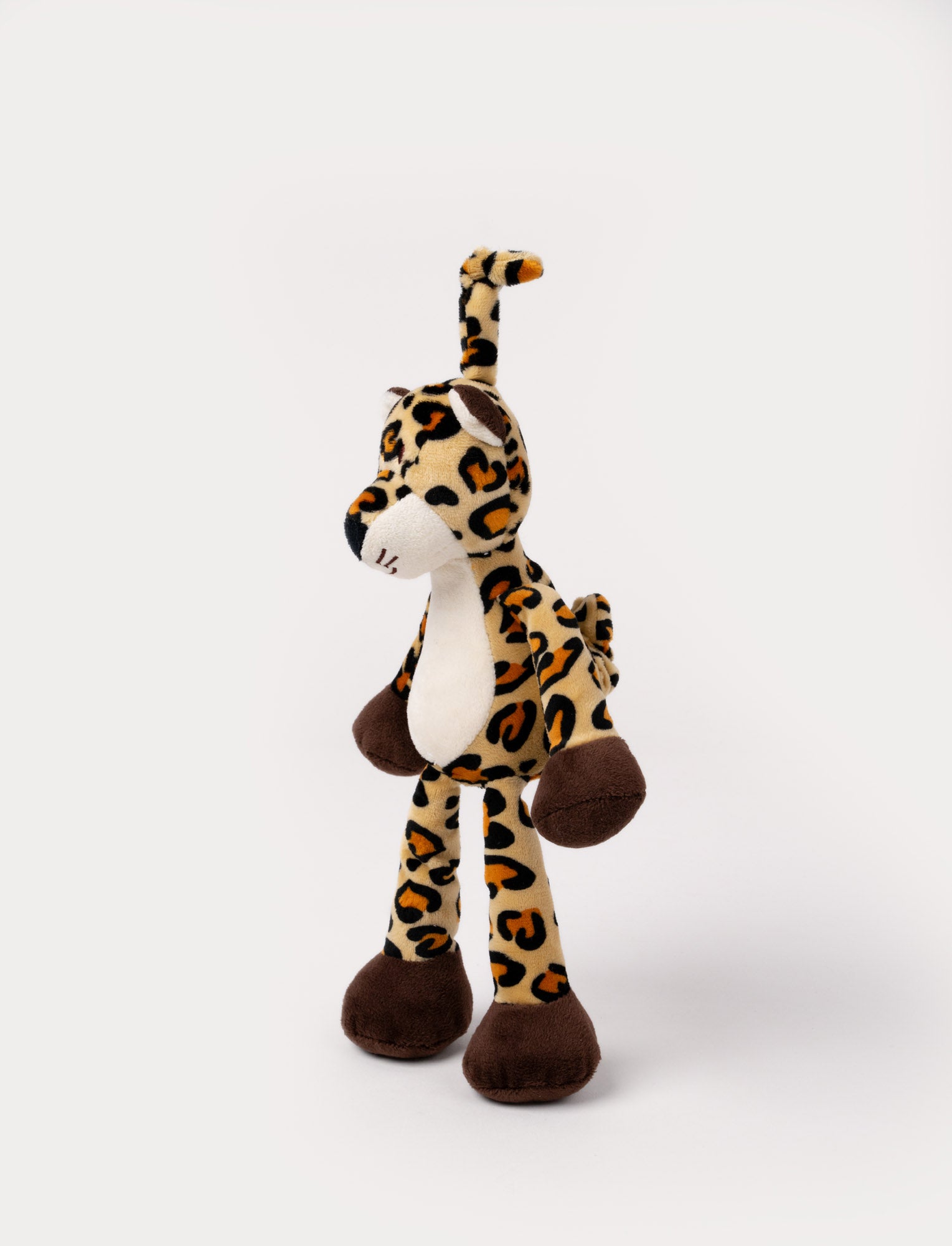 Image of A plush leopard music box with spots, a white belly, brown paws and a hanging loop.