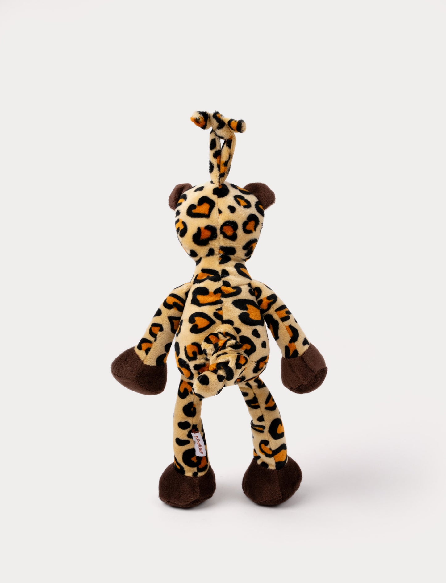 A plush leopard music box with spots, a white belly, brown paws and a hanging loop.
