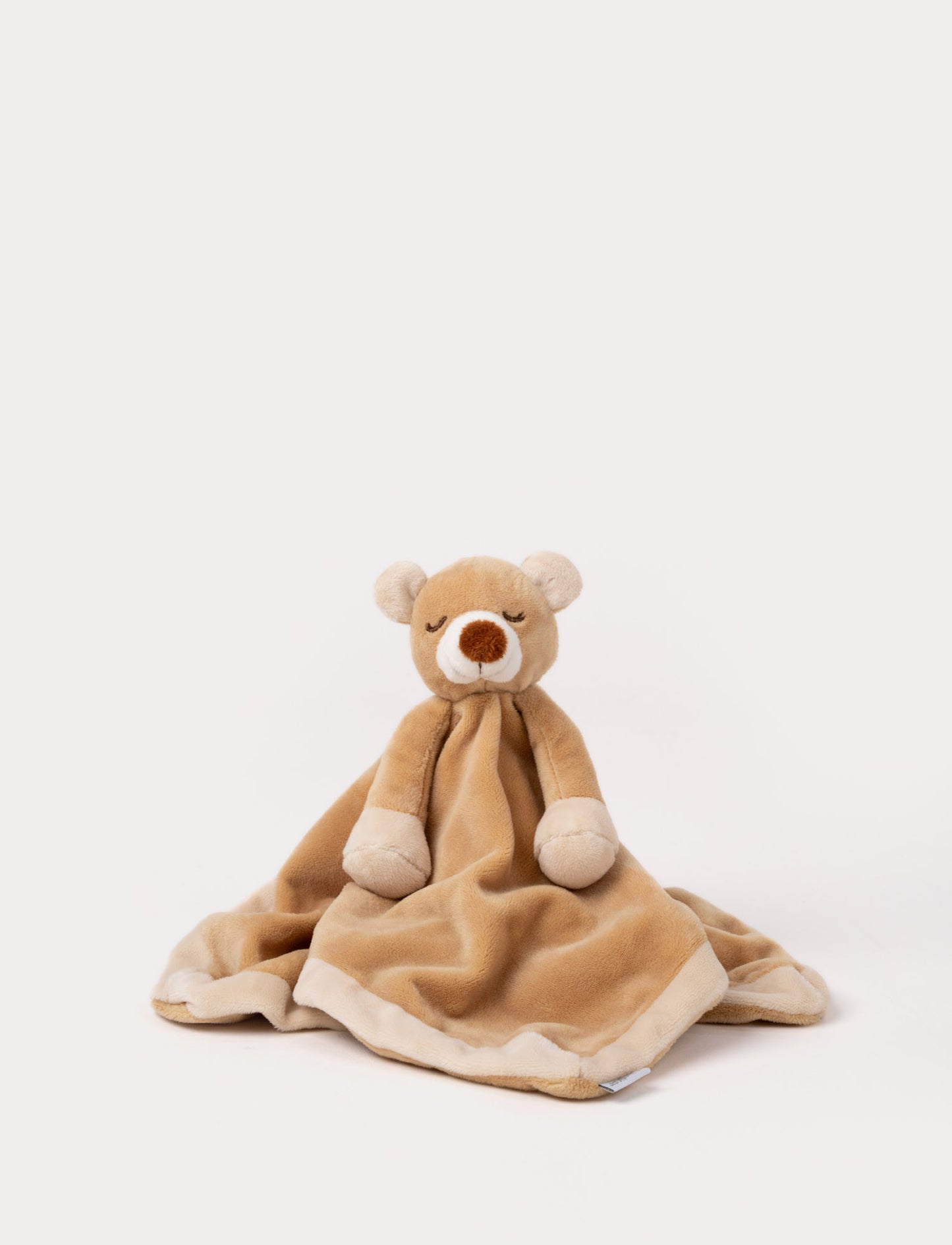 Soft baby blanket with a plush brown bear head, closed eyes, and cream-trimmed edges.