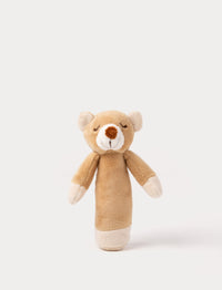 Soft plush bear rattle with a light brown body, embroidered sleeping eyes, a white muzzle, and white accents on the hands and base.
