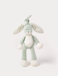 A plush sage green bunny music box with long floppy ears, a white belly, and a hanging loop.