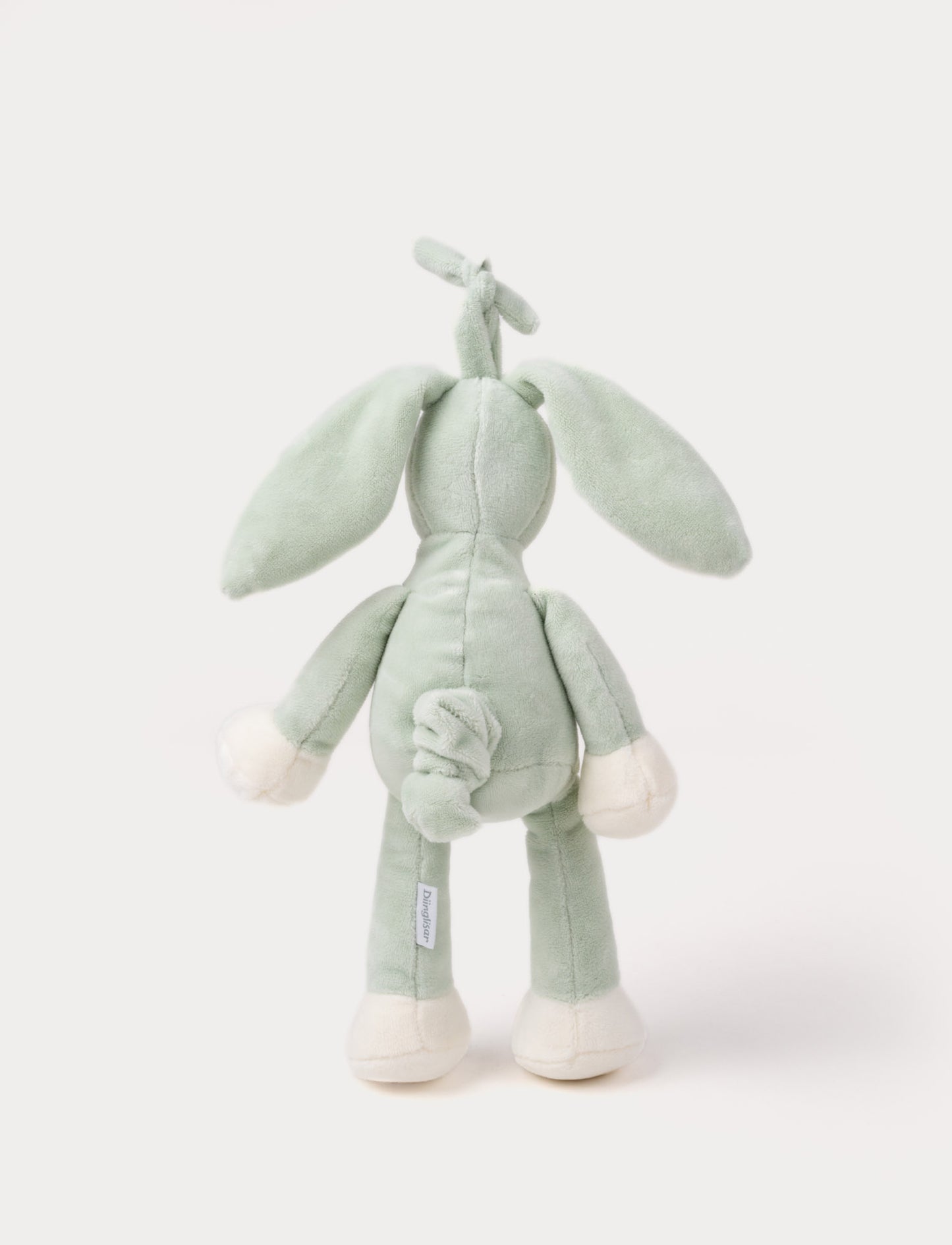 A plush sage green bunny music box with long floppy ears, a white belly, and a hanging loop.