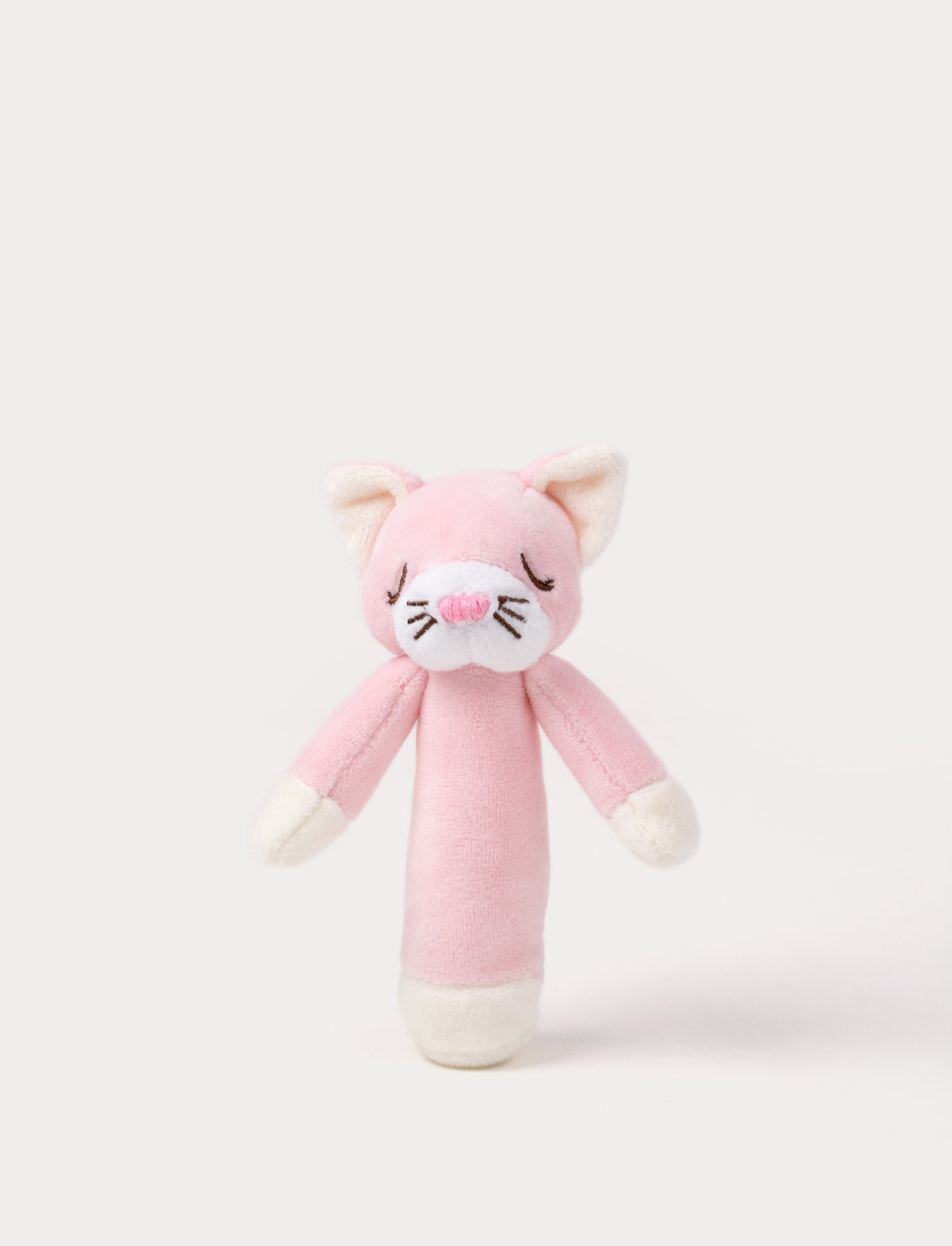 Image of Soft plush cat rattle with a pink body, embroidered sleeping eyes, a white muzzle, and white accents on the hands and base.