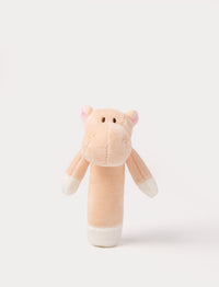 Soft plush hippo rattle with apricot body, embroidered eyes, small pink ears, and white accents on the hands and base.