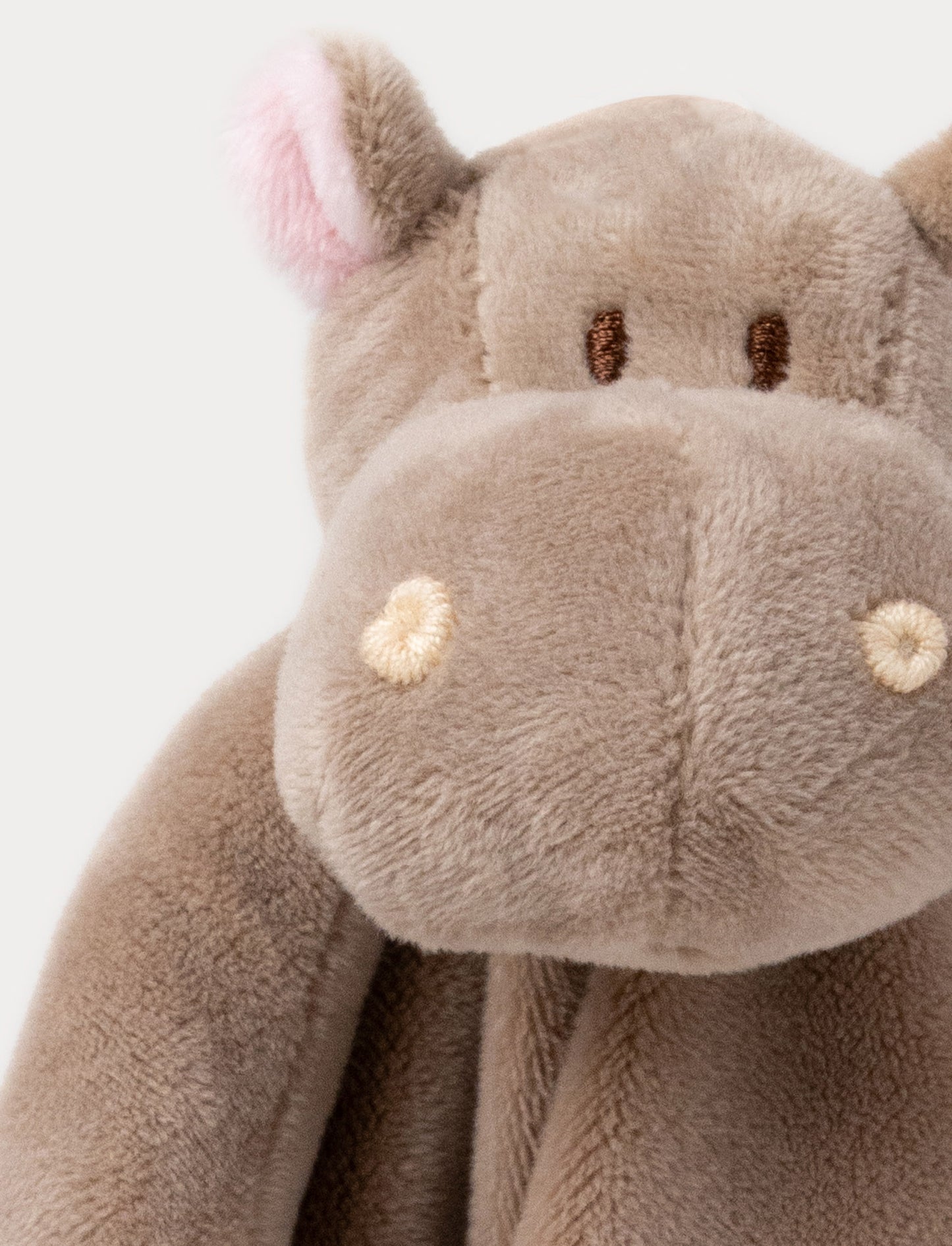 Soft baby blanket with a plush brown hippo head, small pink ears, and white-trimmed edges.