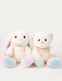 Two plush toys, a bunny and a bear, with white fur and pastel-colored details on ears and paws.