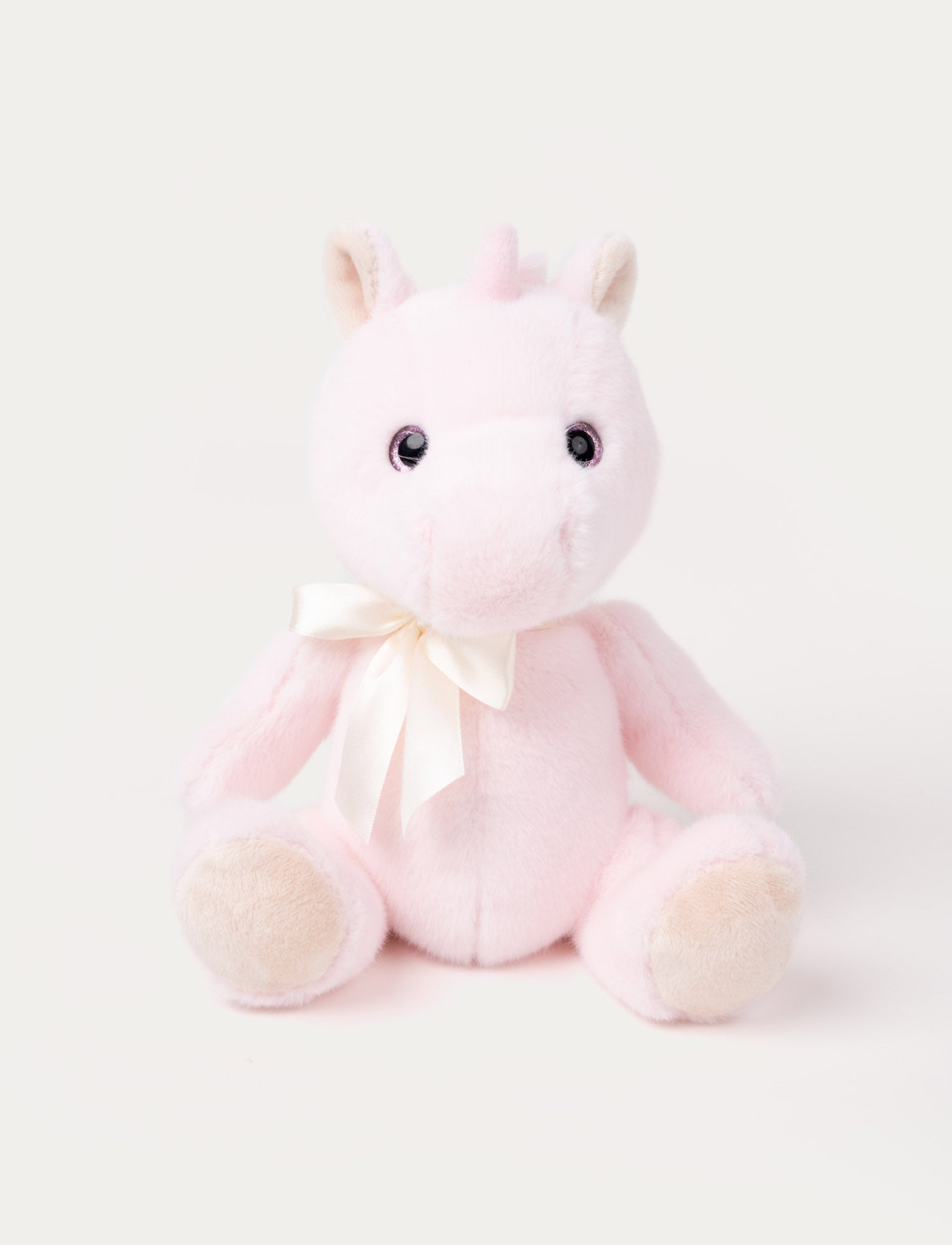  Image of A pink unicorn with a satin bow, sparkling eyes, fluffy ears, and silky, cashmere-like fur.