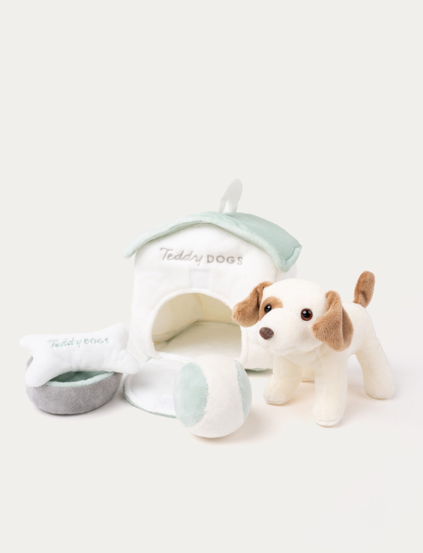 A plush dog with a doghouse, dog bone, water bowl, and ball, perfect for imaginative play.