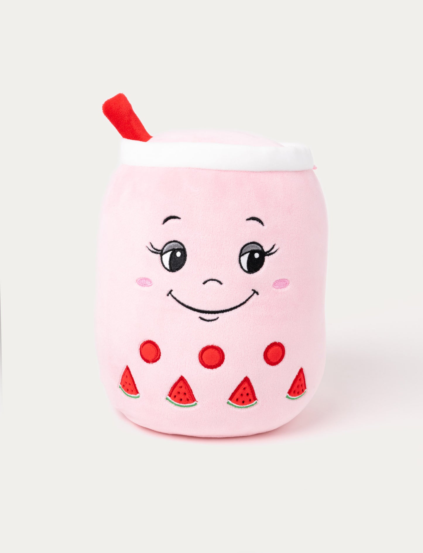 Pink plush toy shaped like a bubble tea cup with a smiling face, red straw, and embroidered watermelon details.