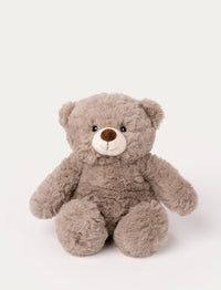 Soft beige teddy bear plush with a round body, fluffy fur, and a stitched smiling face.