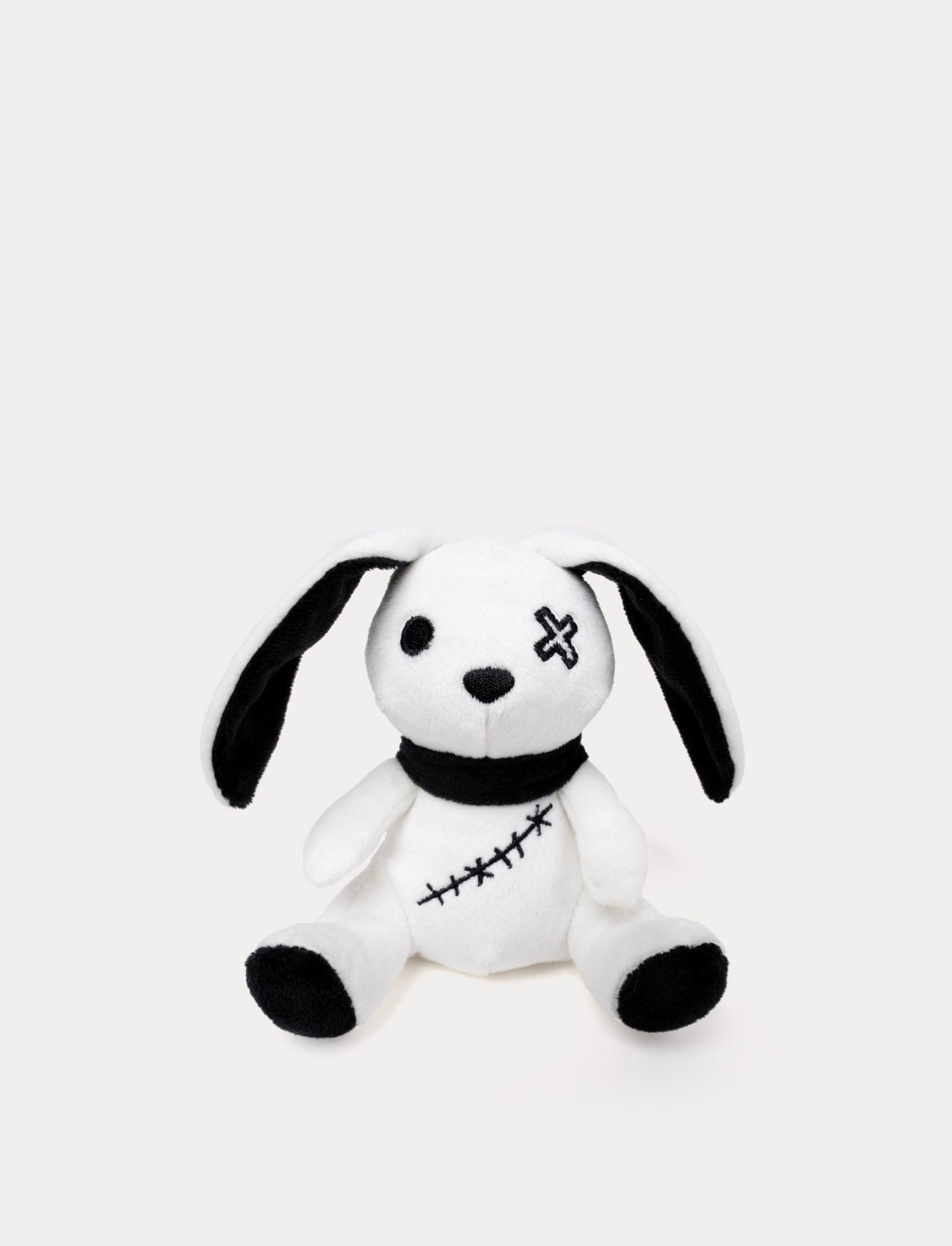  Image of Soft white bunny plush toy with glow-in-the-dark effect. Halloween design.