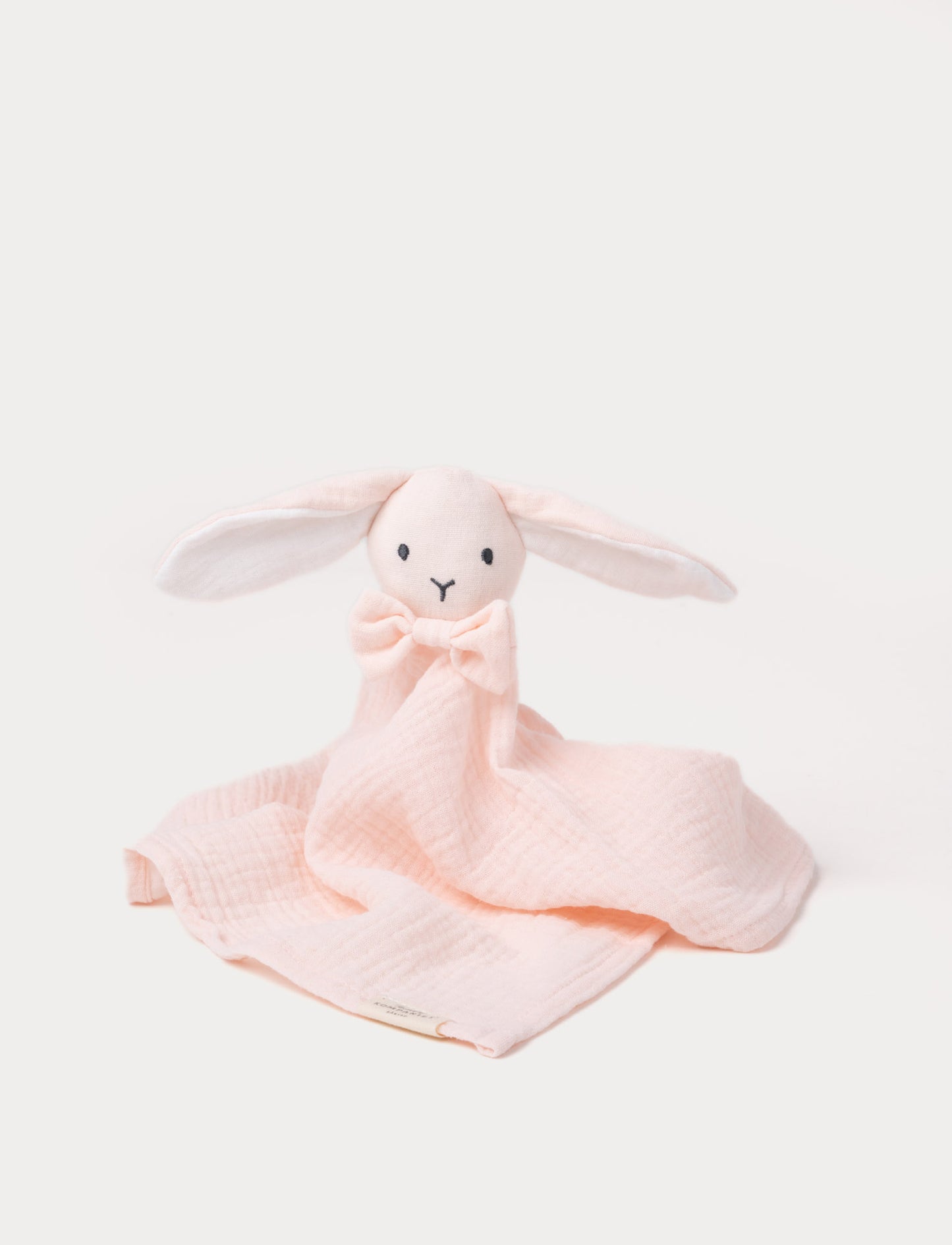 Soft baby blanket with a plush pink bunny head, long floppy ears, and a small bow.