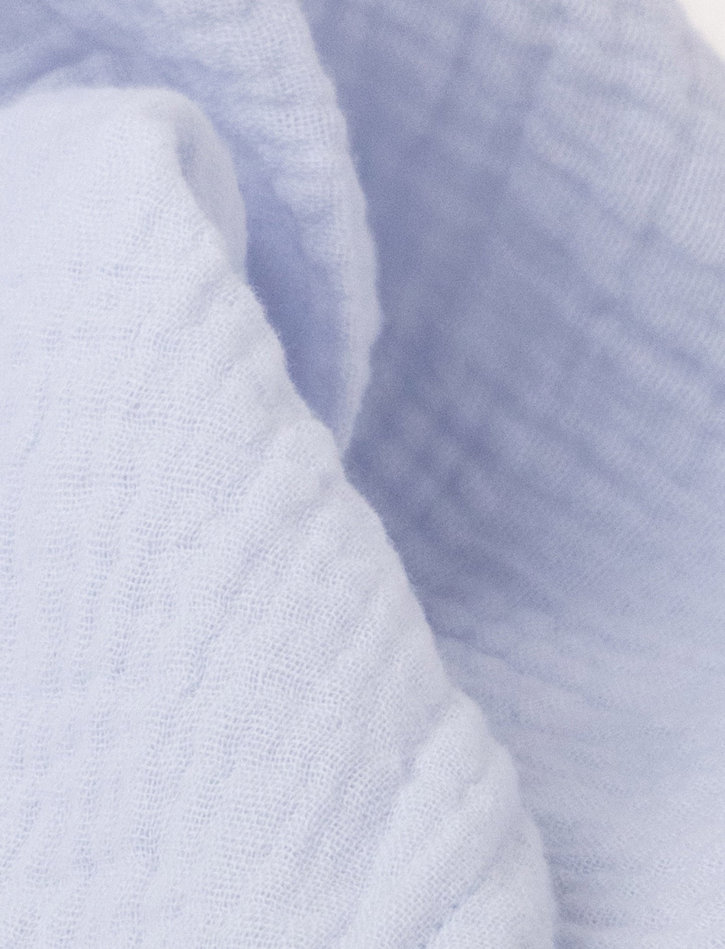 Soft baby blanket with a plush light blue ,levander, bunny head, long floppy ears, and a small bow.