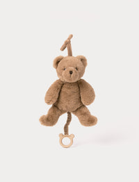 Brown plush teddy bear musical toy with pull string and wooden ring.