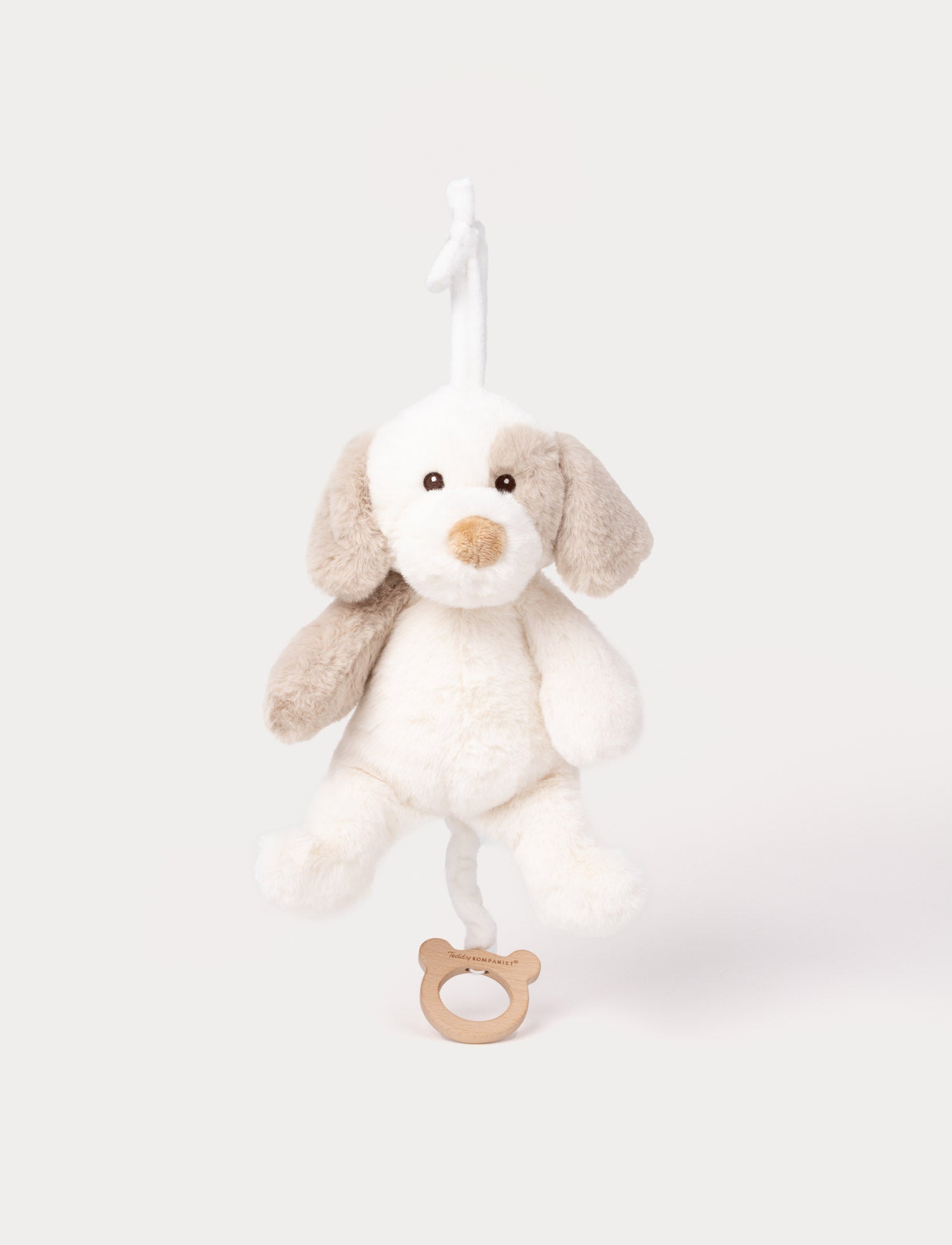  Image of Soft musical plush dog toy with beige and white fur and wooden pull ring.