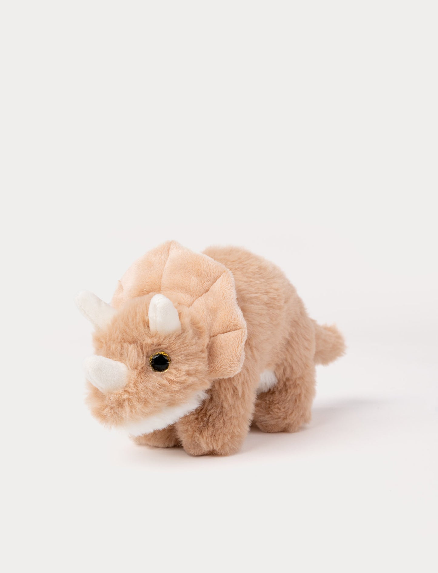 Soft peach Triceratops dinosaur plush toy with fluffy fur and three white horns