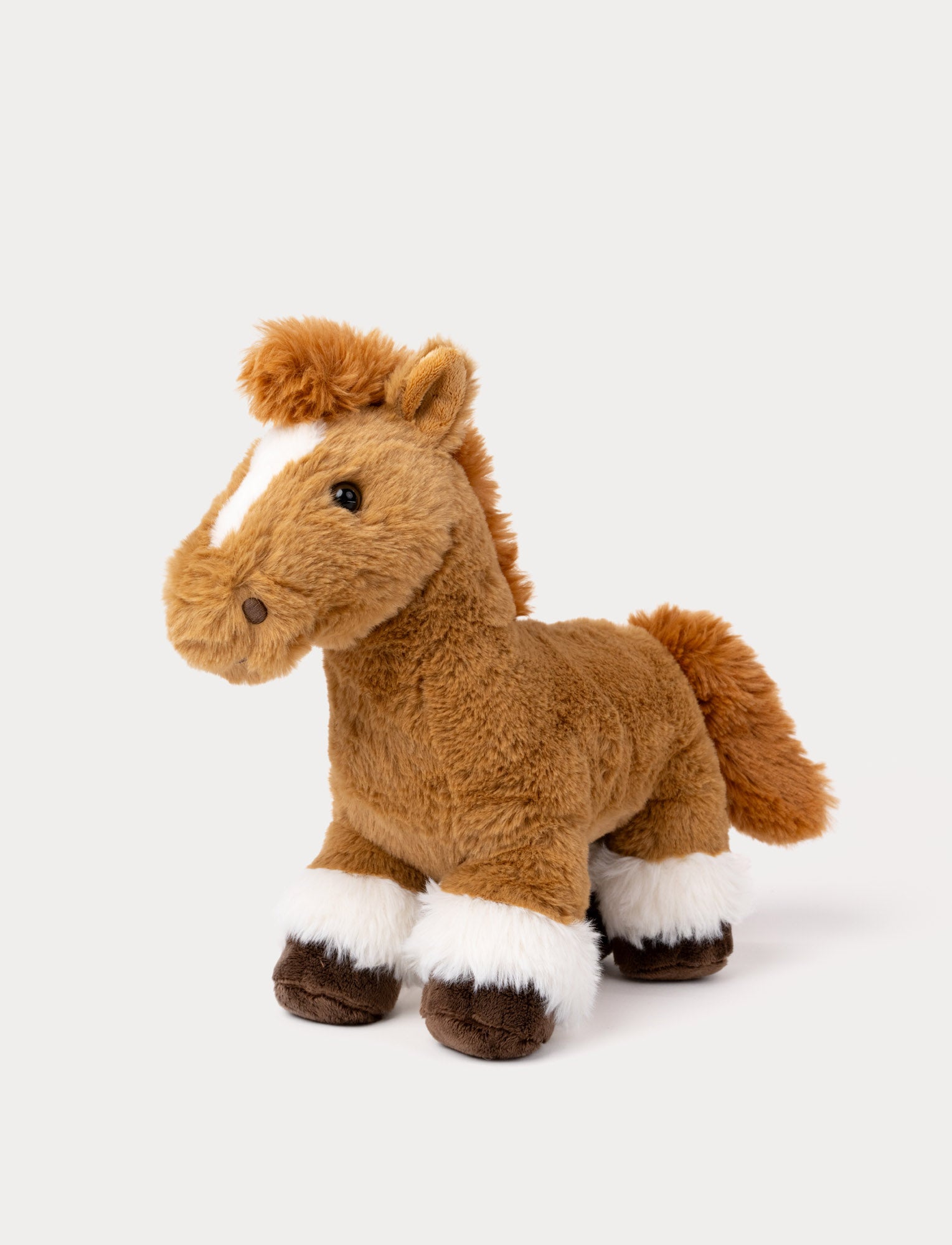  Image of Soft brown horse plush toy with fluffy mane, white blaze, and furry hooves.